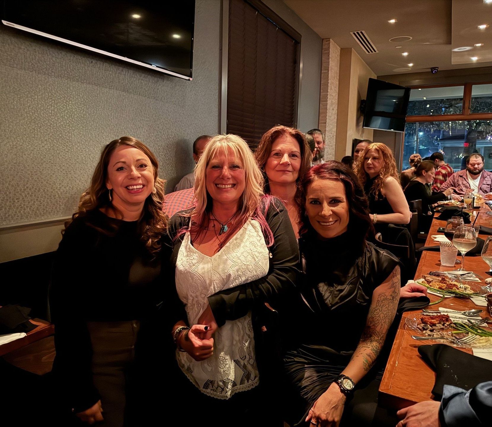 A group of women are posing for a picture in a restaurant.