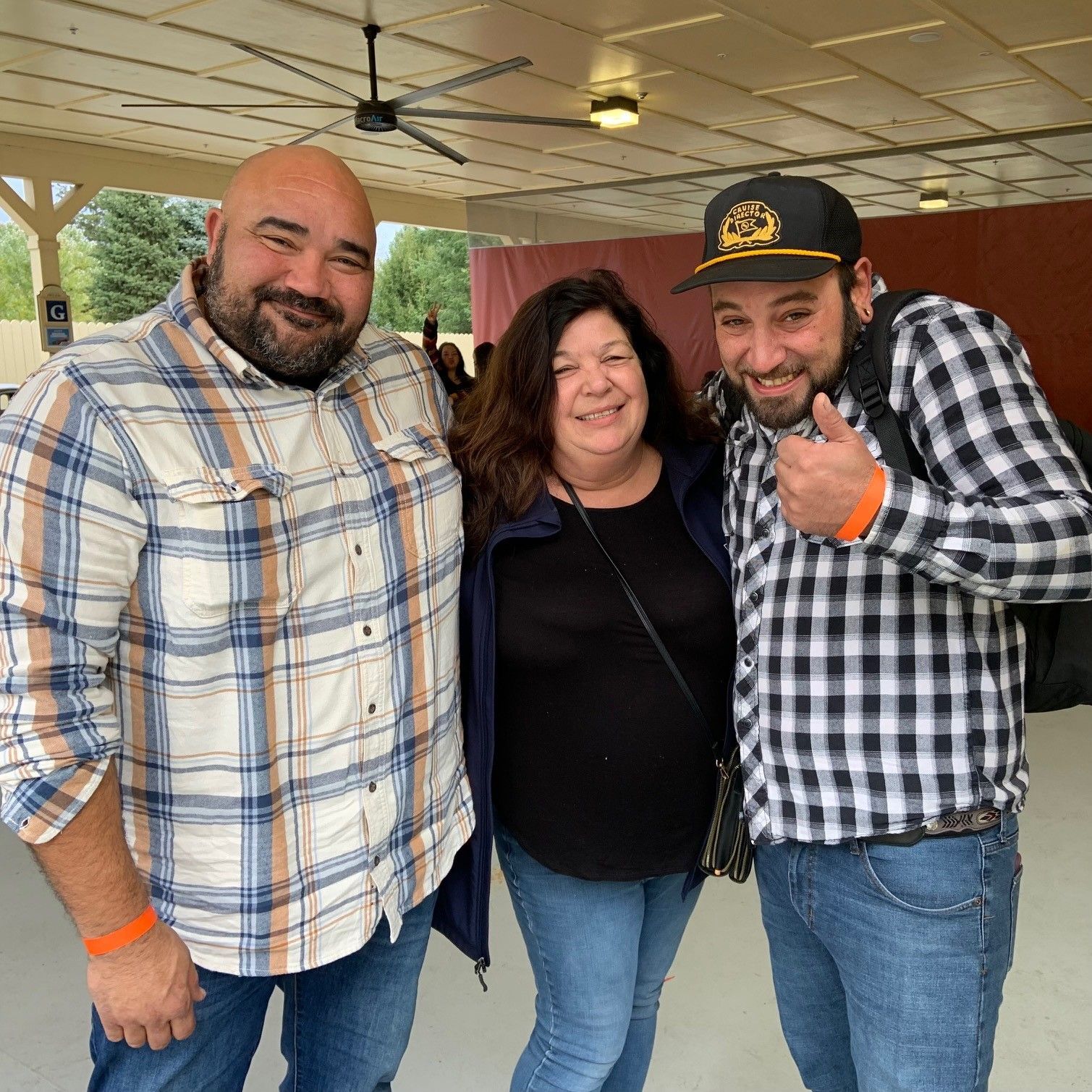 Two men and a woman are posing for a picture together