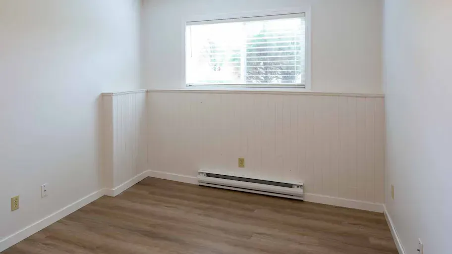 A room with a baseboard heater in it. A room with a baseboard heater in it.