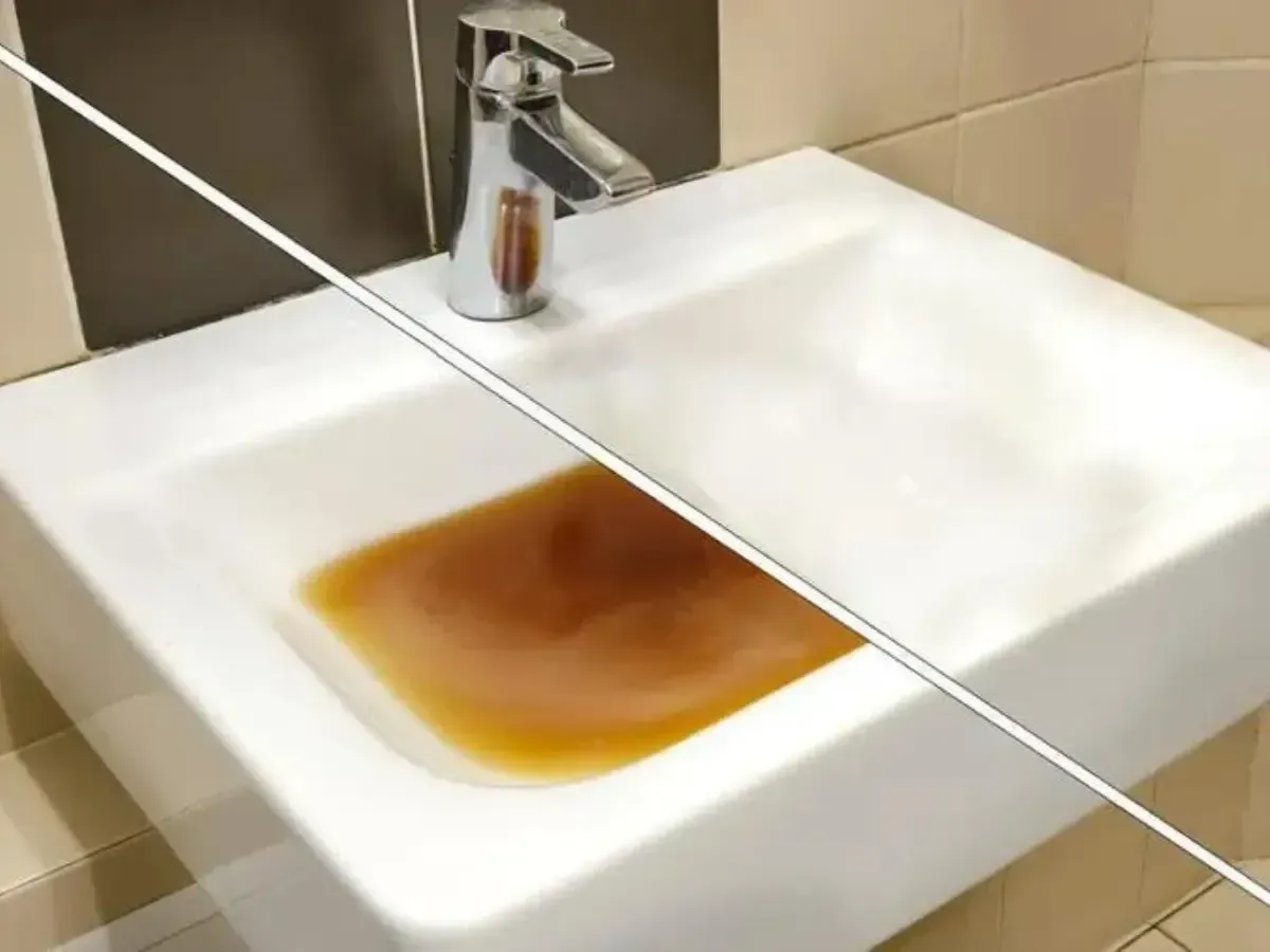 A bathroom sink with a brown liquid in it