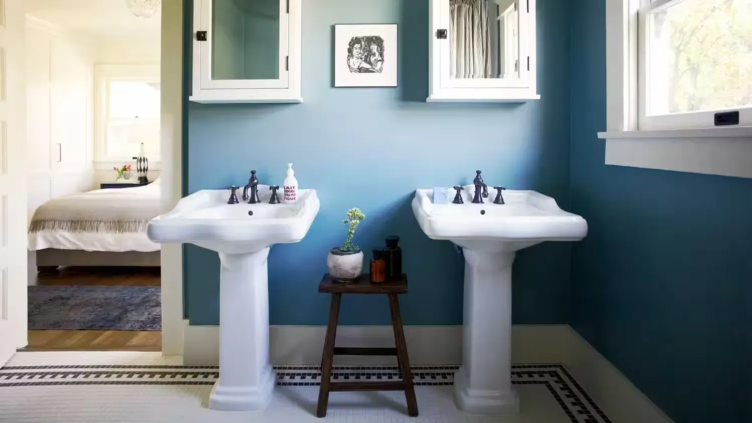 A bathroom with two sinks and a stool in it A bathroom with two sinks and a stool in it