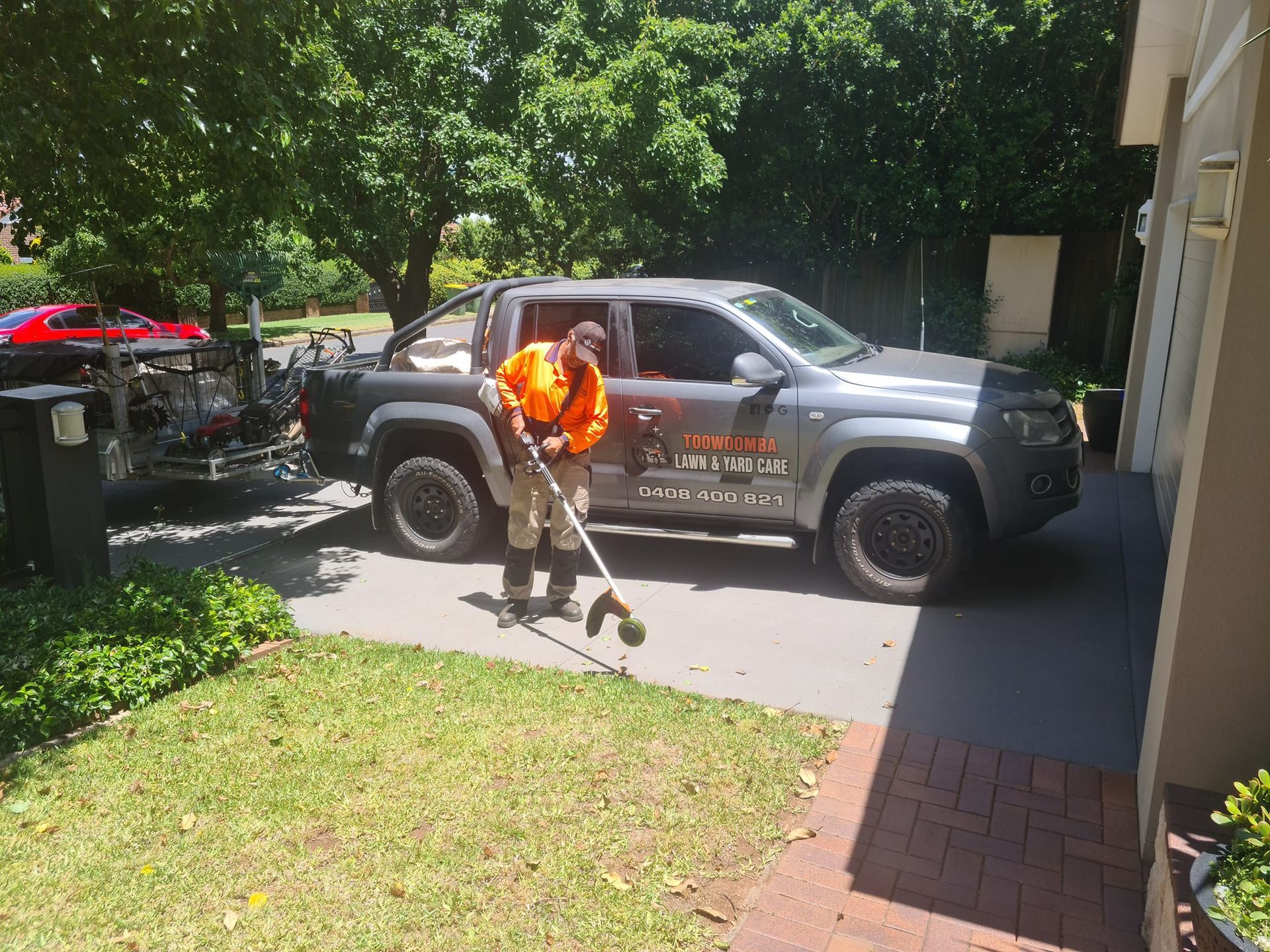 Worker in Vest Using a Leaf Blower — Toowoomba Lawn and Yard care In Highfields, QLD