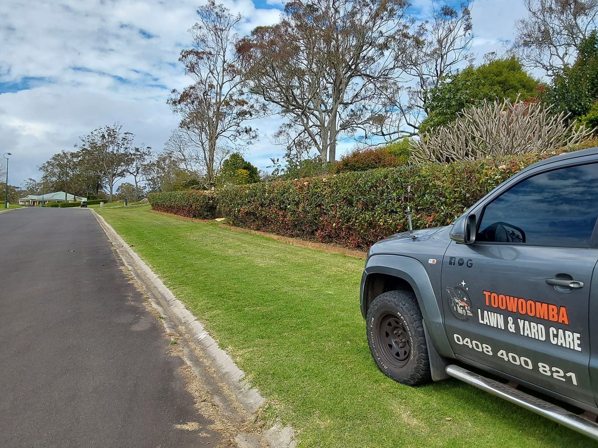 Parked Service Truck Beside a Grassy Roadside — Toowoomba Lawn and Yard care In Highfields, QLD