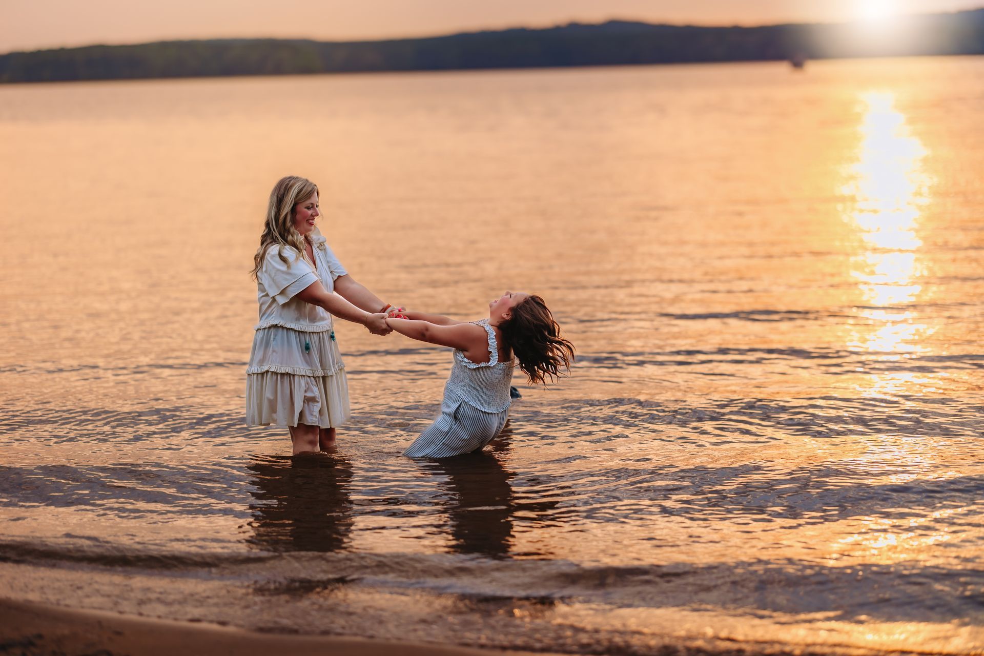 Mother and Daughter Playing in the water during the golden hour at Jordan Lake NC