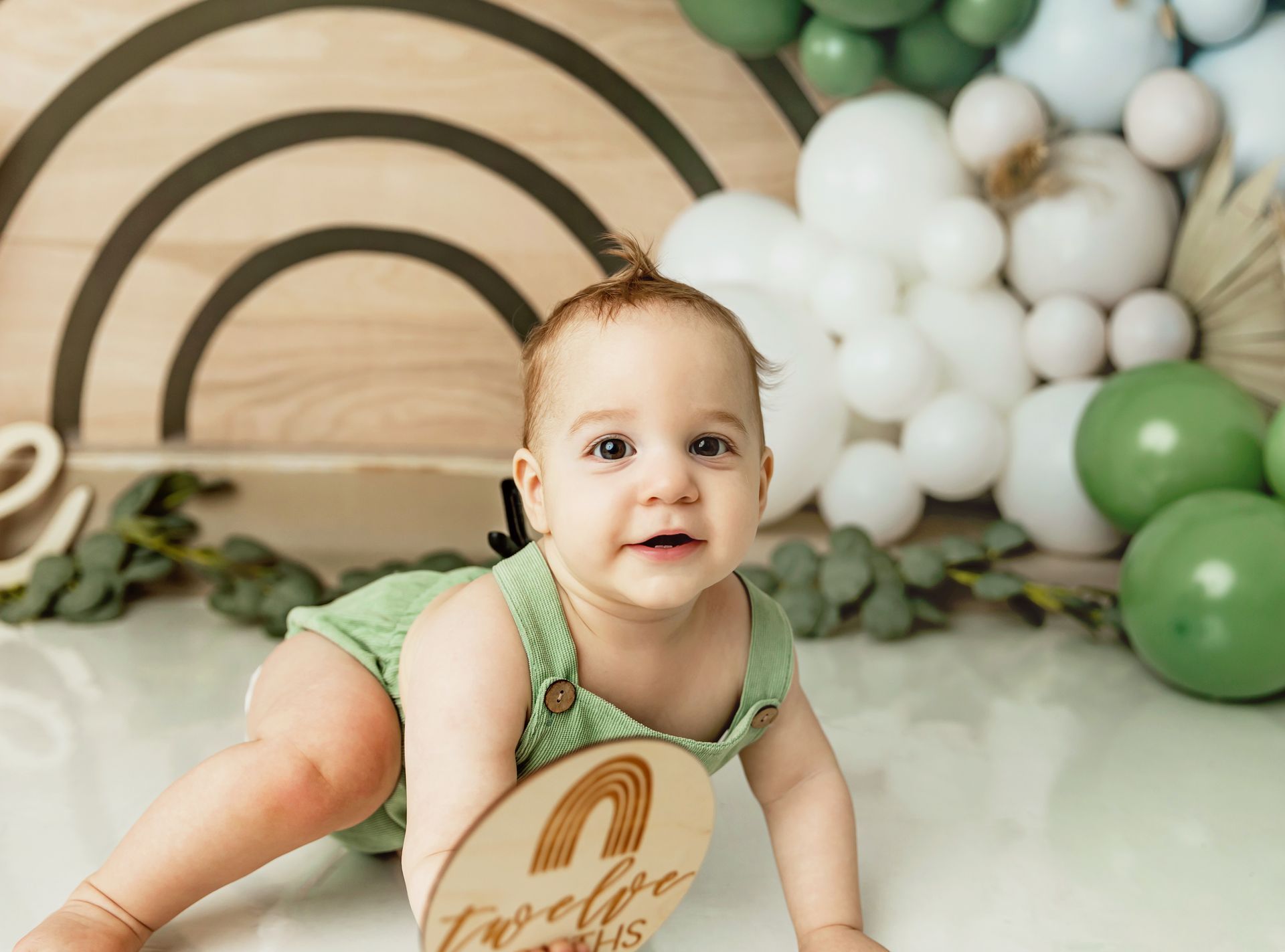Neutral baby boy first birthday setup with earthy tones and balloon arch | Boho cake smash photography Raleigh NC