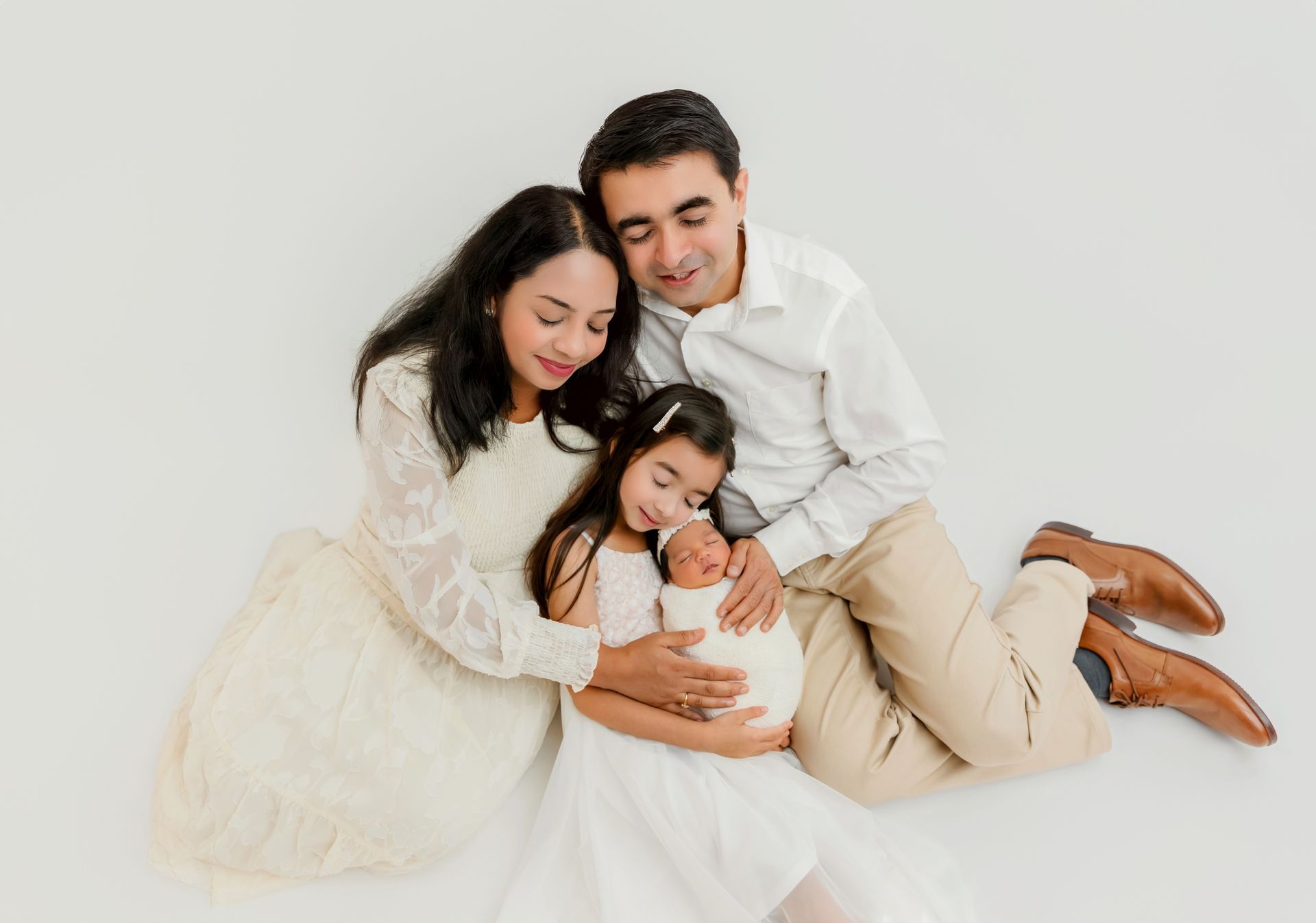 Family and newborn in studio session Cary NC