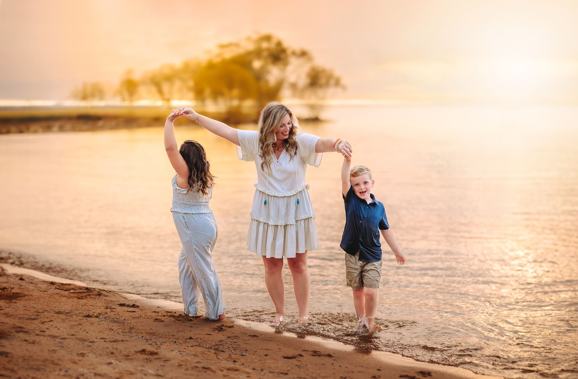 Mother and children playing in the summer jordan lake NC lakeshore at the sunset time