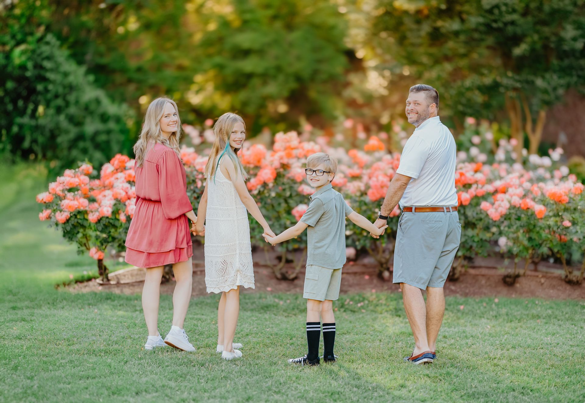 Family holding hands photoshoot at Raleigh Rose Garden summer