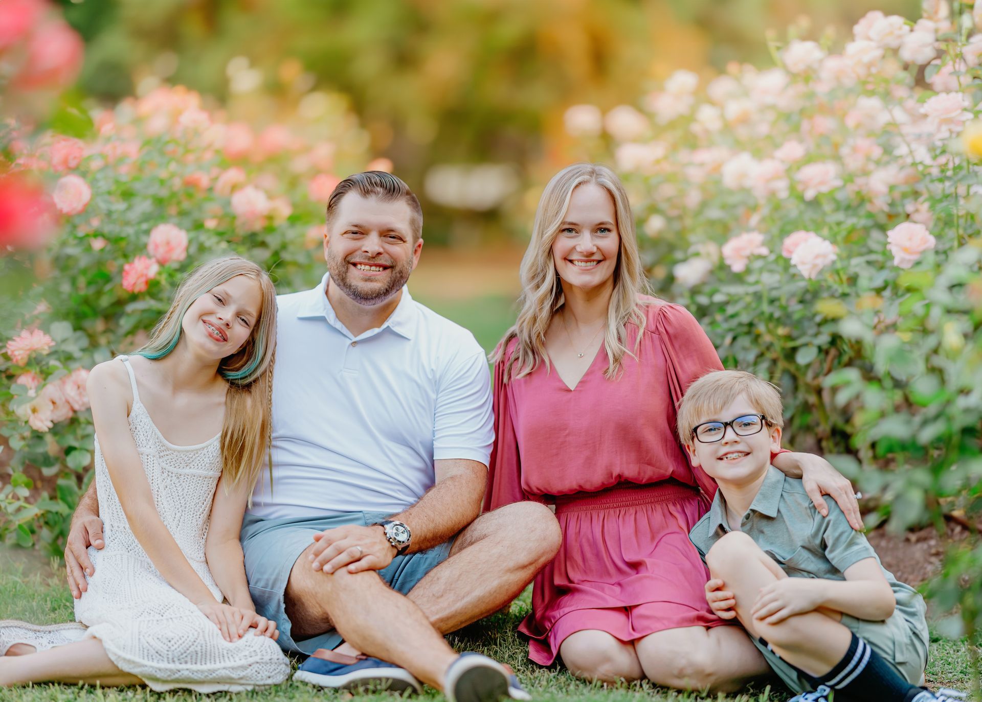 Family posing among the blooms at the Raleigh Rose Garden