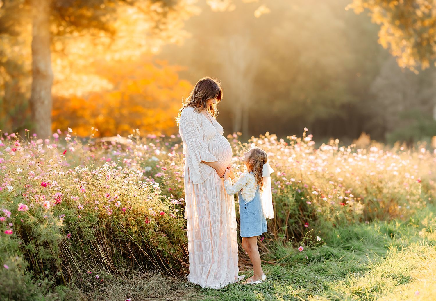 mother and daughter maternity session flower field in Raleigh