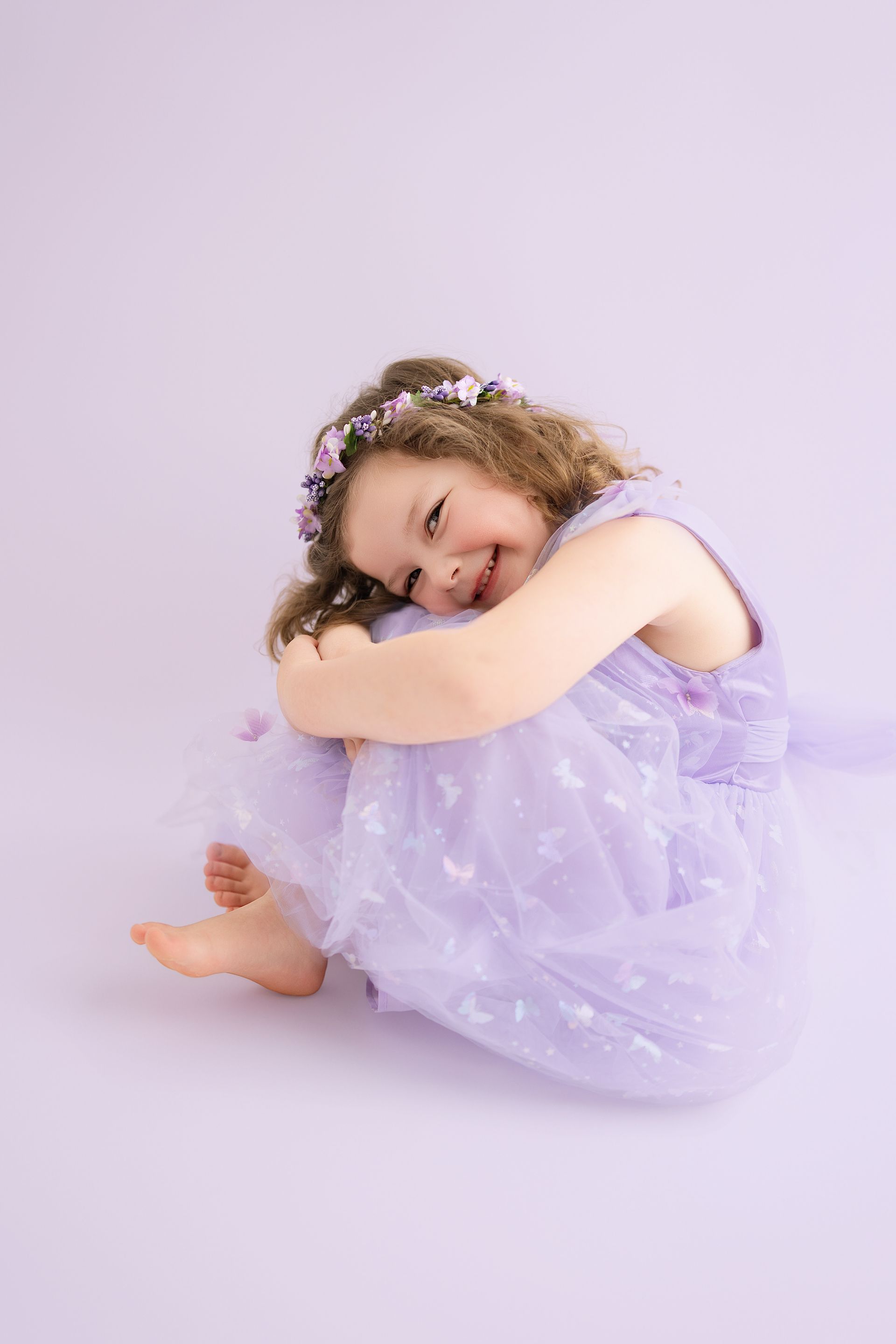 4-year-old girl posing proudly during her milestone studio photoshoot