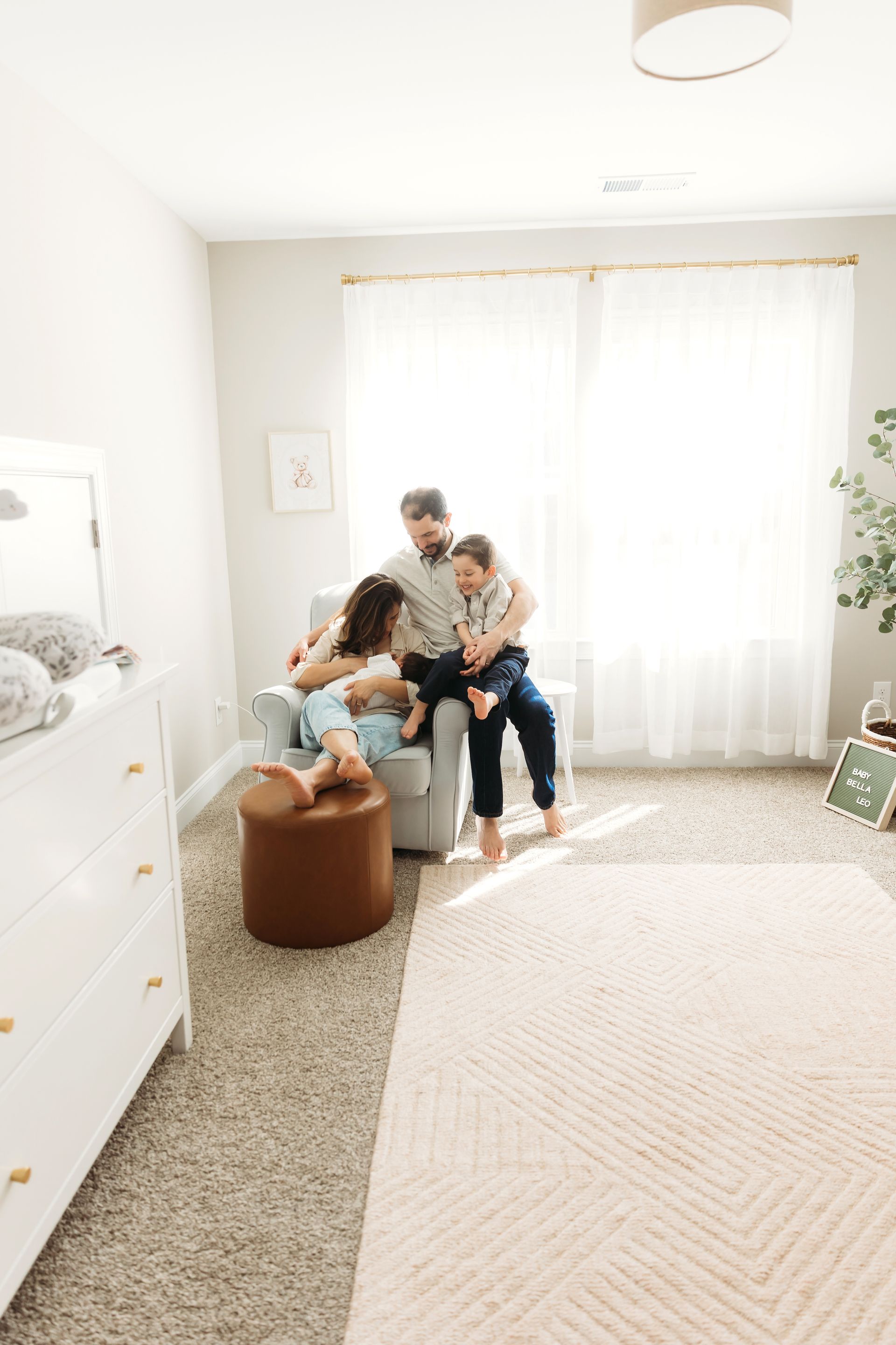 family and the baby posing for the newborn in-home session portraits with Luciana Galucci Photography