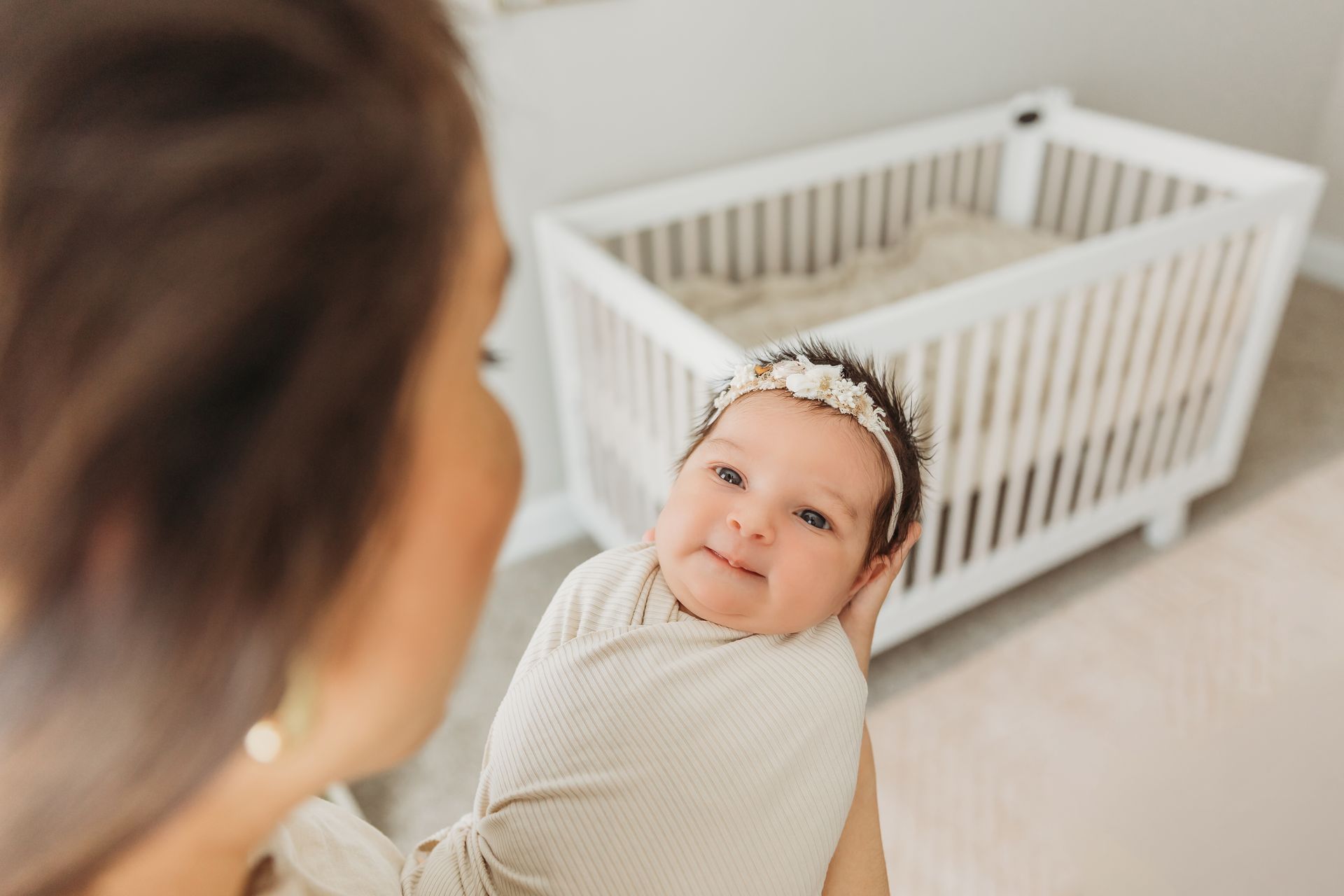 newborn baby looking at her mom during the newborn in-home session portraits with Luciana Galucci Photography