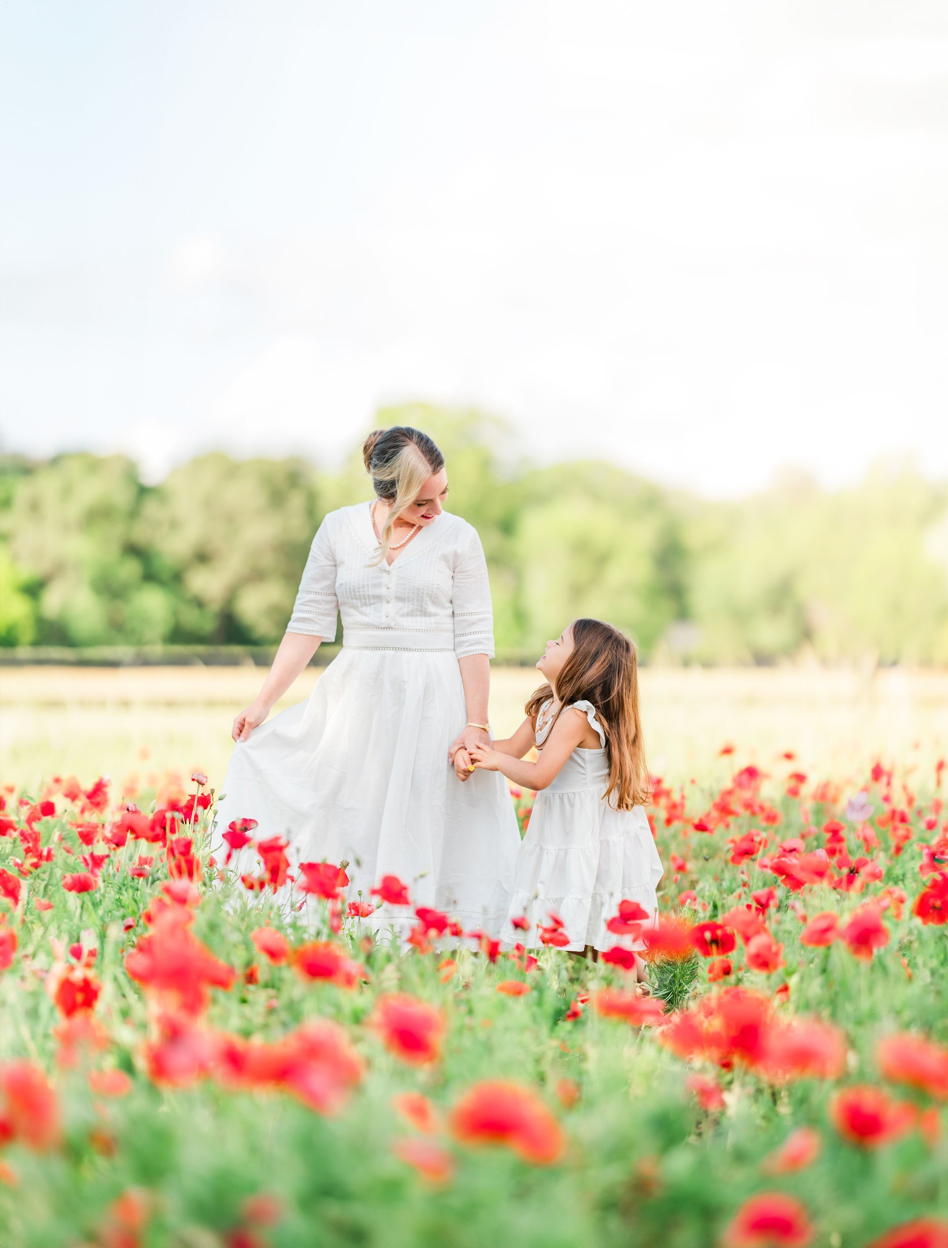 Mother’s Day portrait session in a vibrant red poppy field with natural light