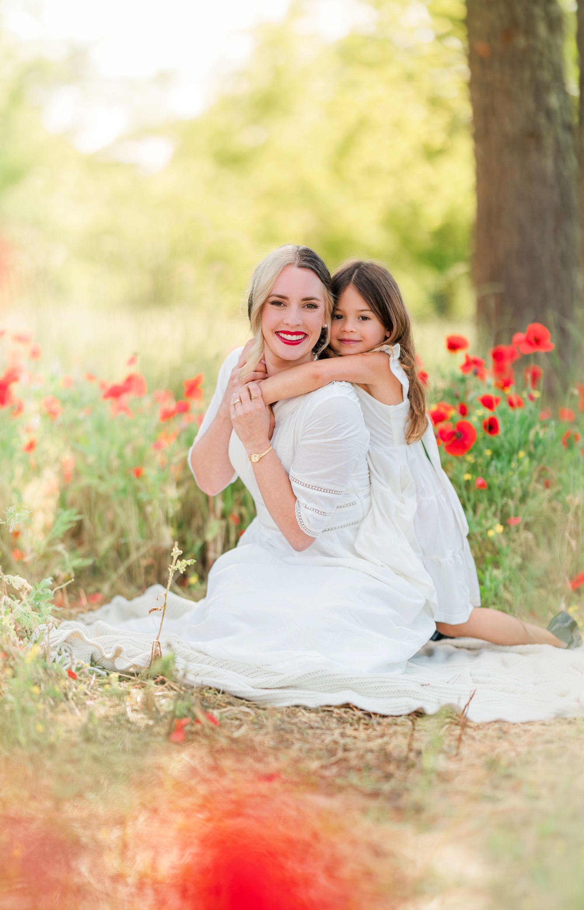 Mother’s Day portrait session in a vibrant red poppy field with natural light