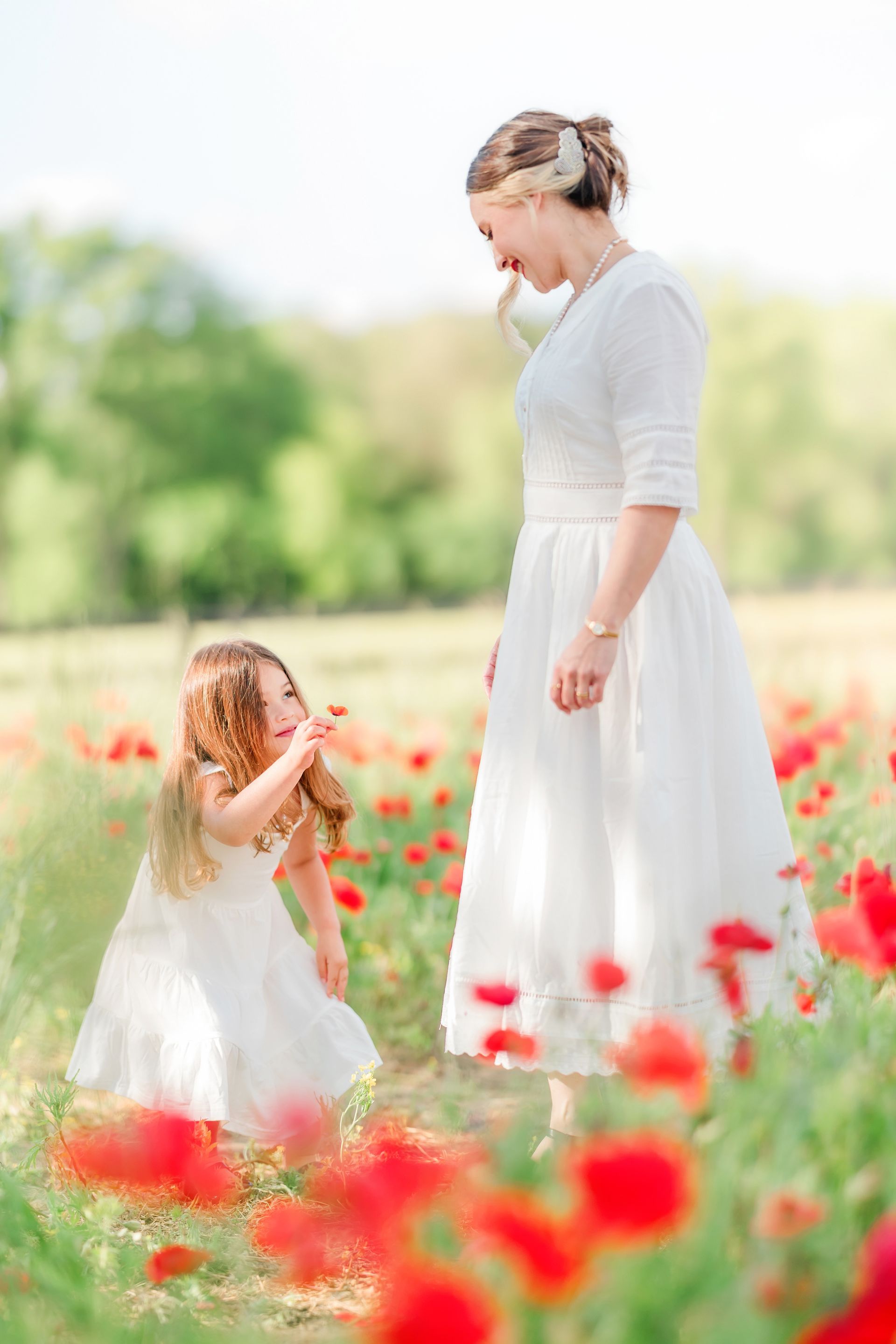Mother and child portrait in a red poppy field on a sunny spring day in Raleigh, NC
