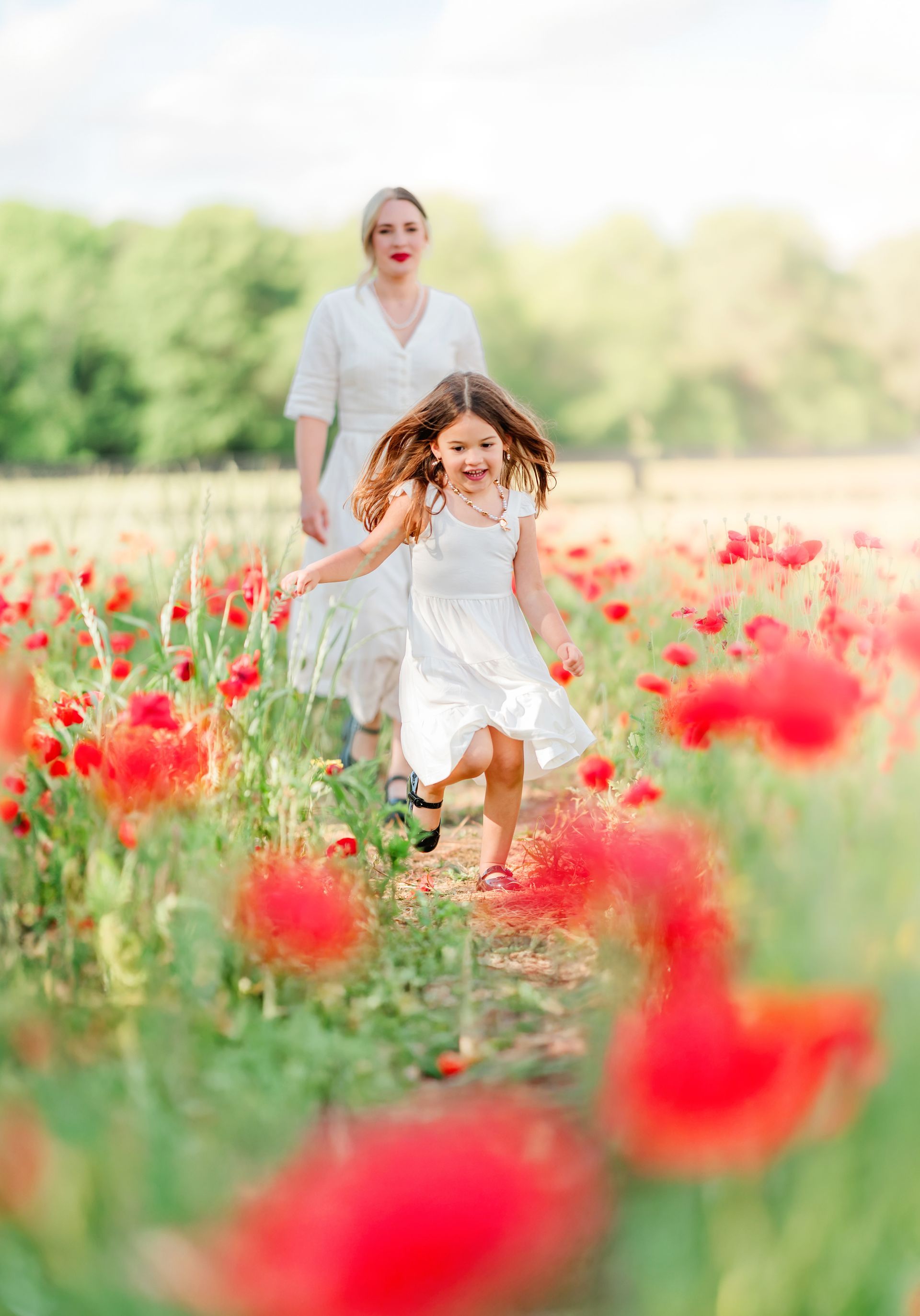 Mother and child portrait in a red poppy field on a sunny spring day in Raleigh, NC