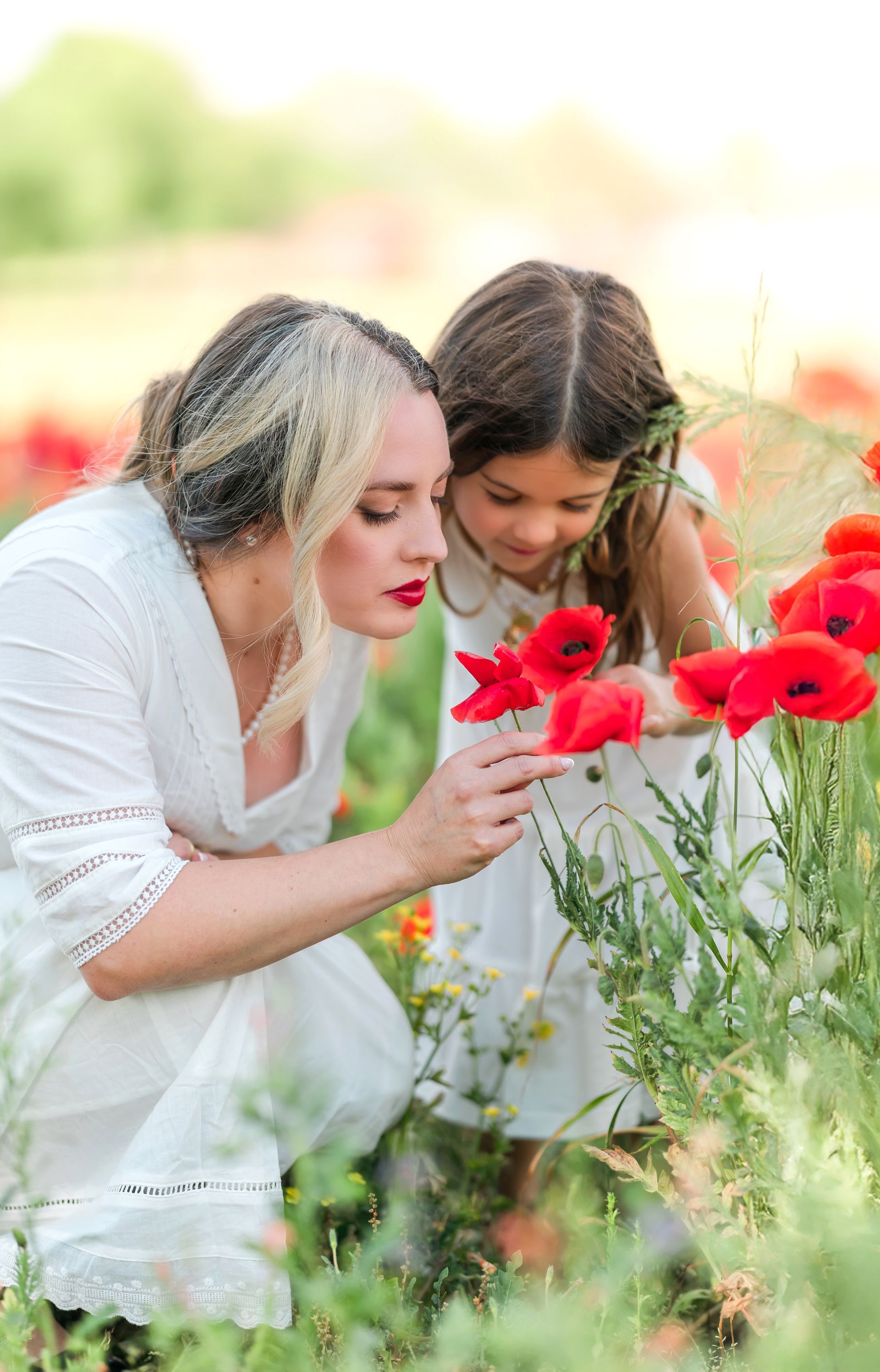 Spring portrait session in a red poppy field on a bright, sunny day in Raleigh