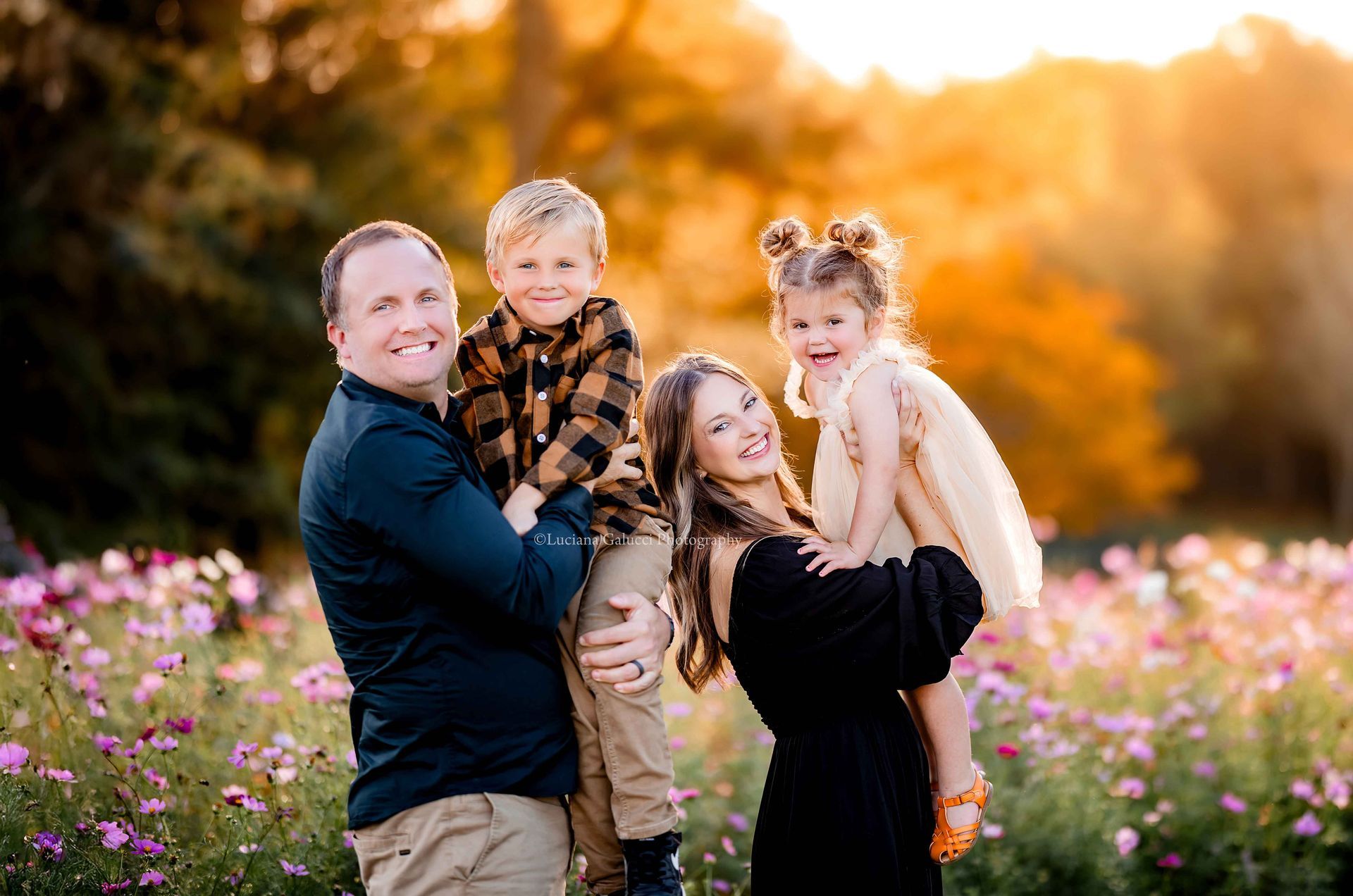 Happy family with mom, dad, and siblings enjoying a golden hour photo session in a flower field in R