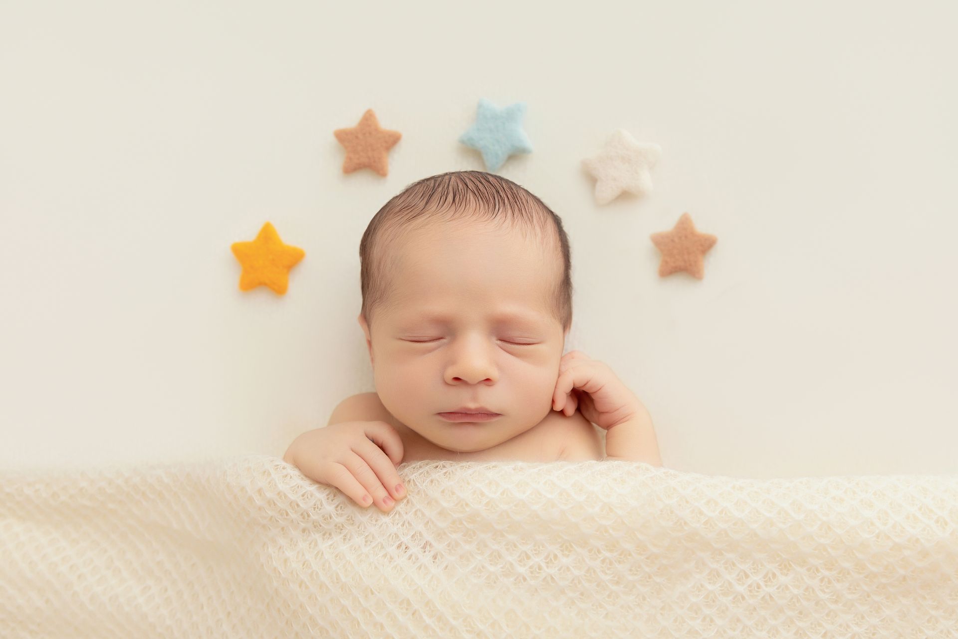 Newborn studio session in Cary NC, baby boy sleeping peacefully with stars props