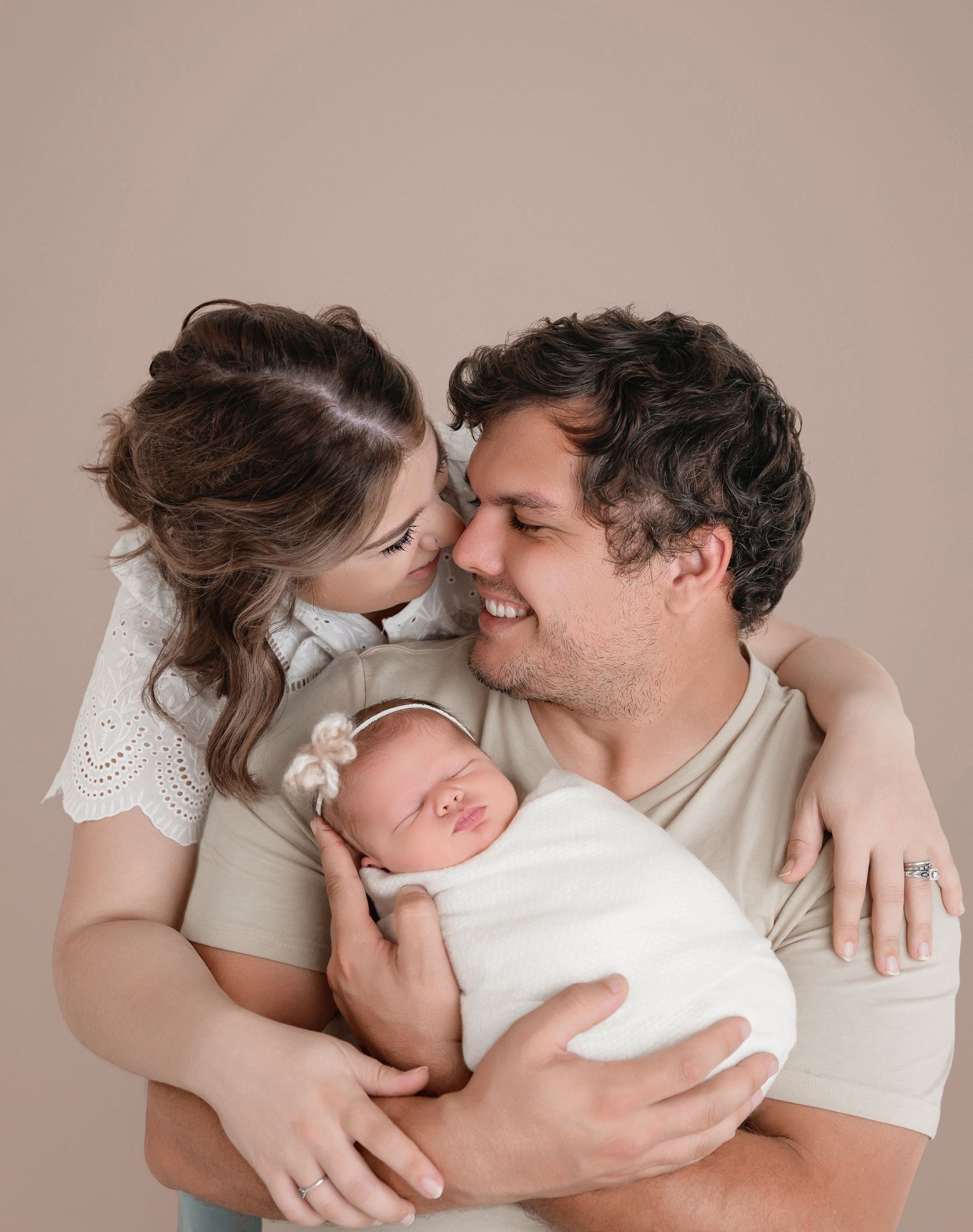 family of 3 posing during the newborn studio portraits session in nCary