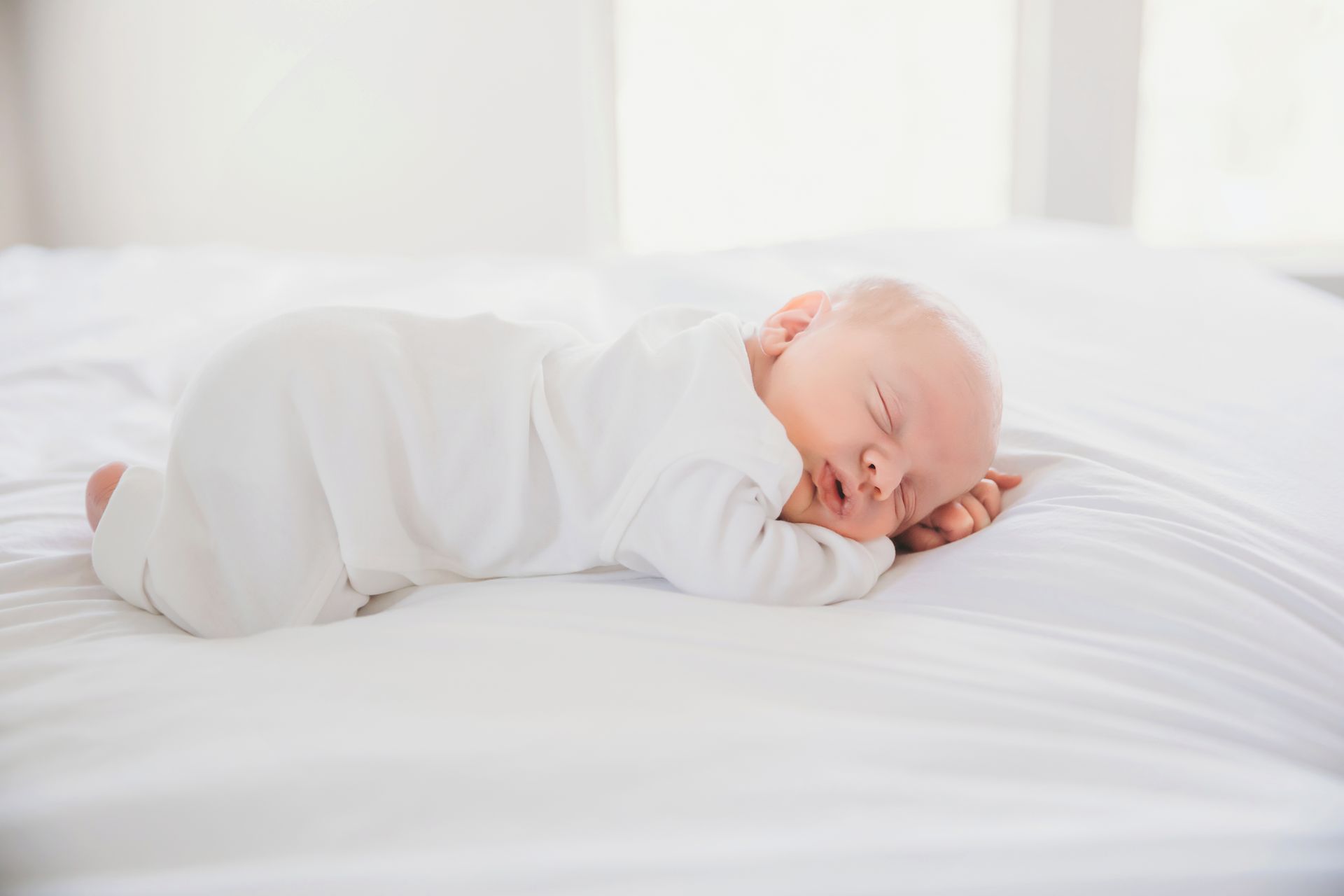 newborn sleeping in the bed during