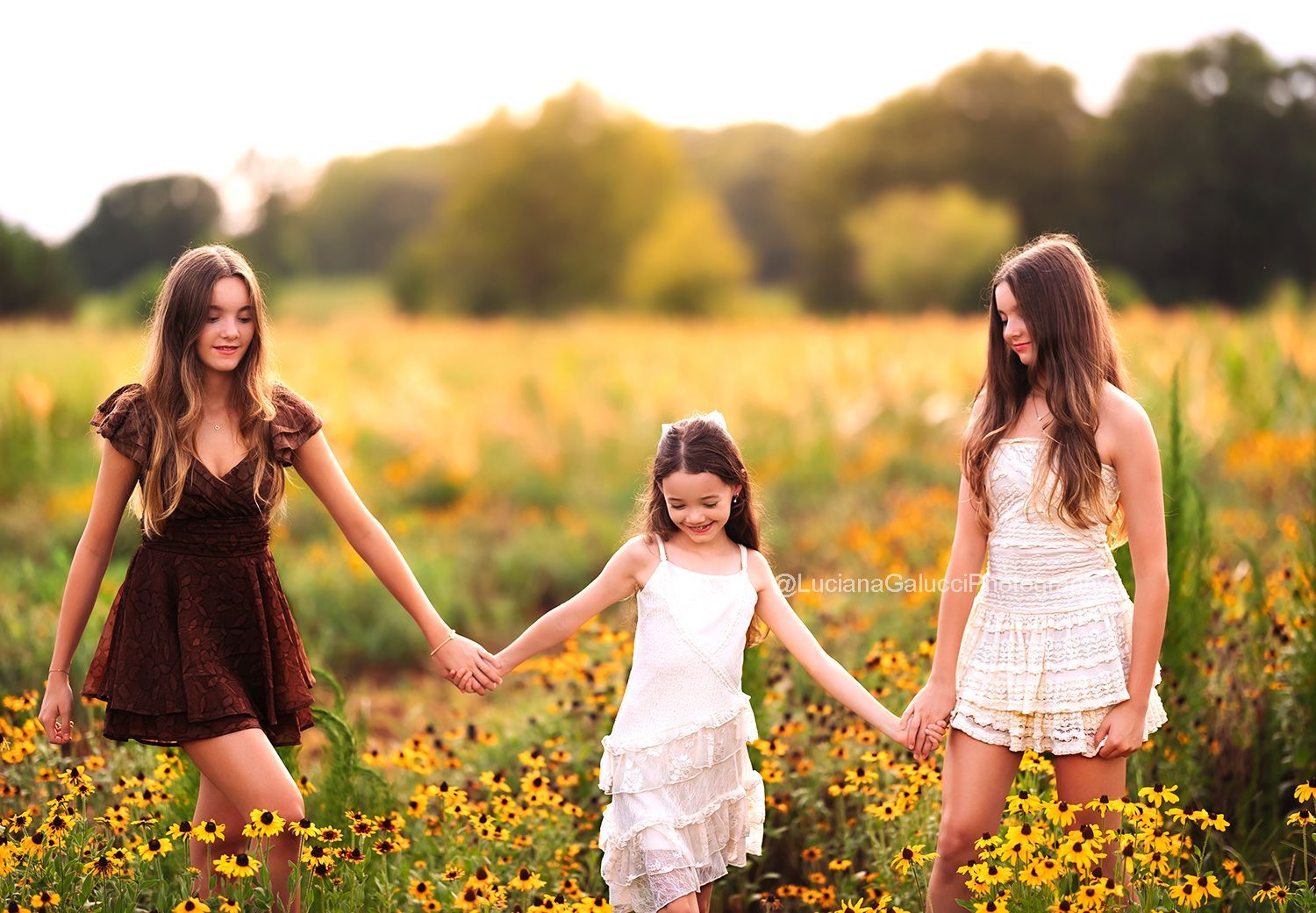 Siblings candid portrait surrounded by wildflowers at sunset in Raleigh, North Carolina.