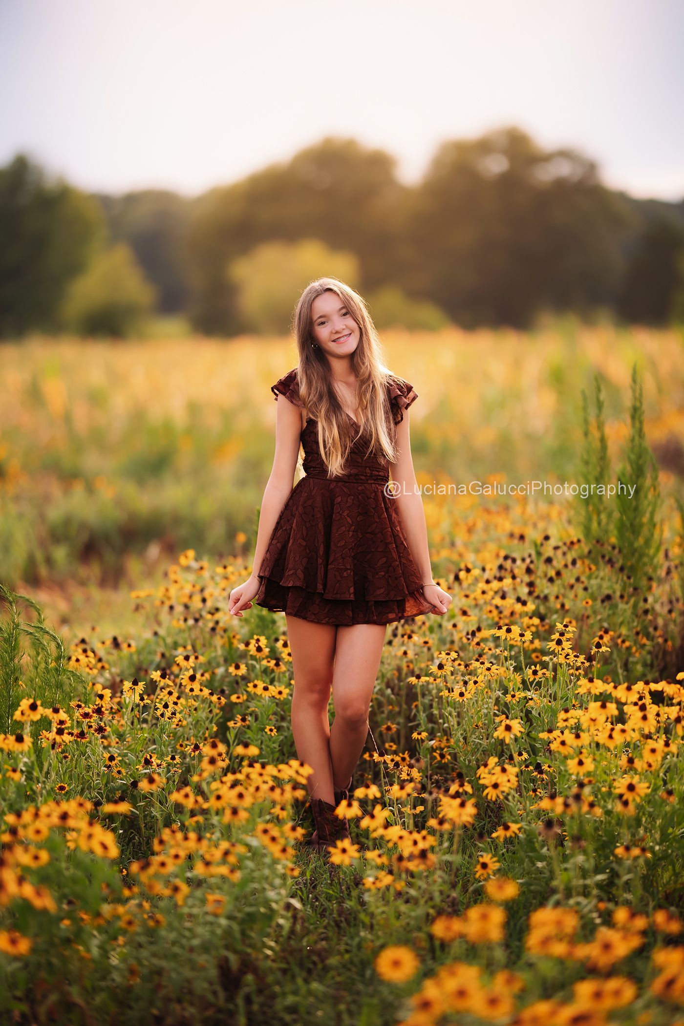 Teen candid portrait surrounded by wildflowers at sunset in Raleigh, North Carolina.