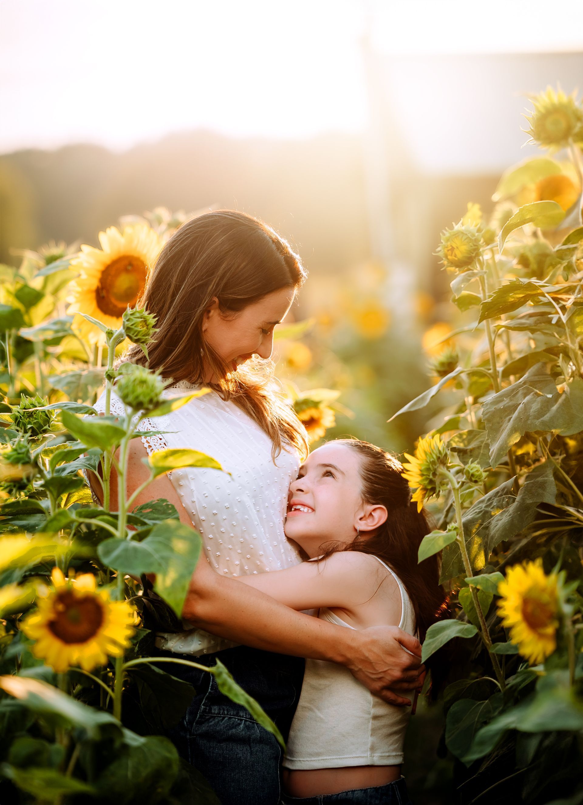 mother and daughter at the sunflowers field during the summer in Raleigh