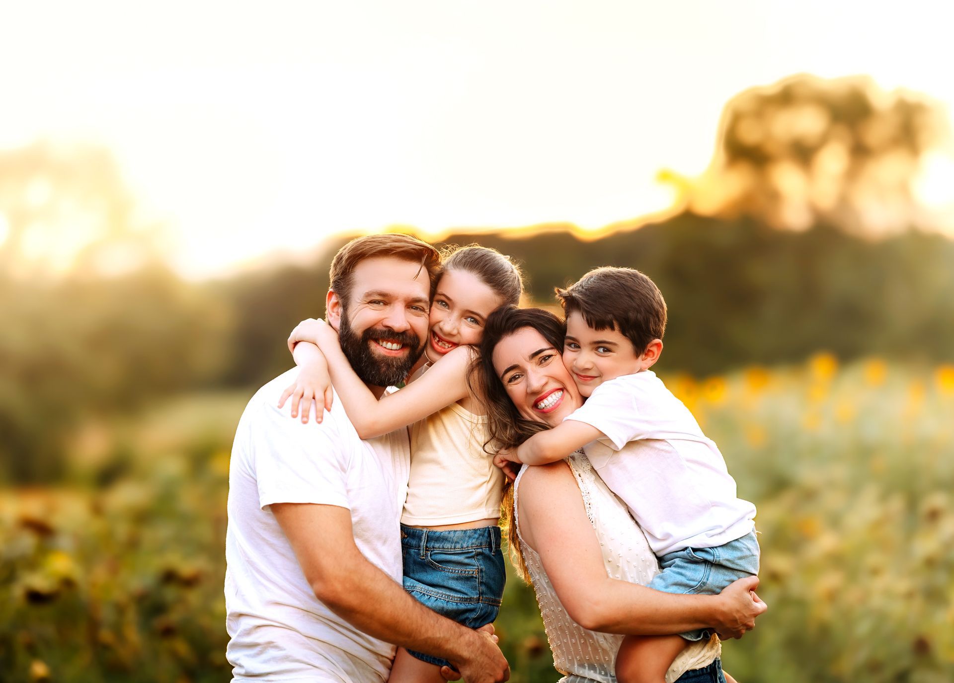 Family smiling in the Sunflowers field in Raleigh during the summer Family Photoshoot