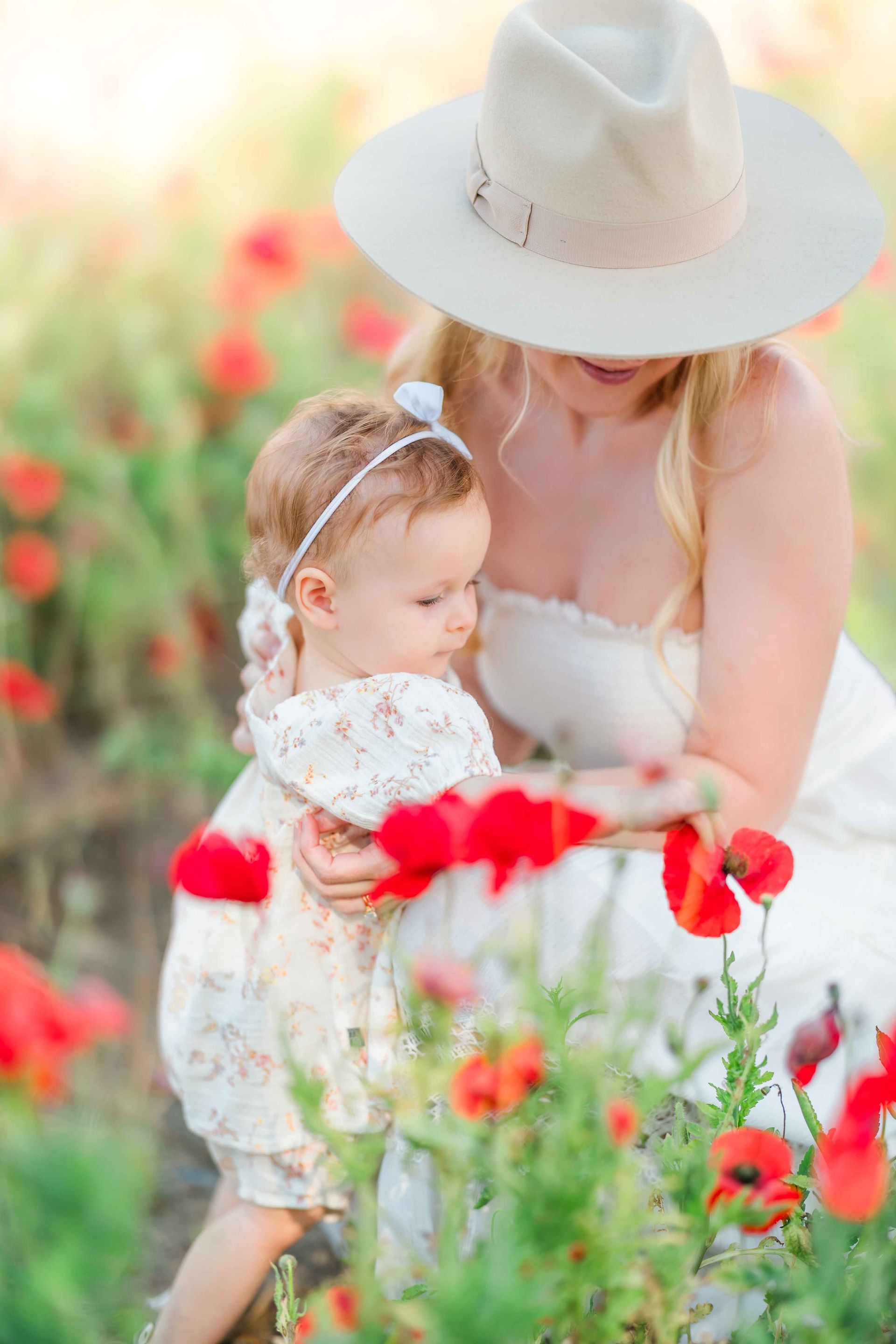 Mother’s Day portrait session in a vibrant red poppy field with natural light