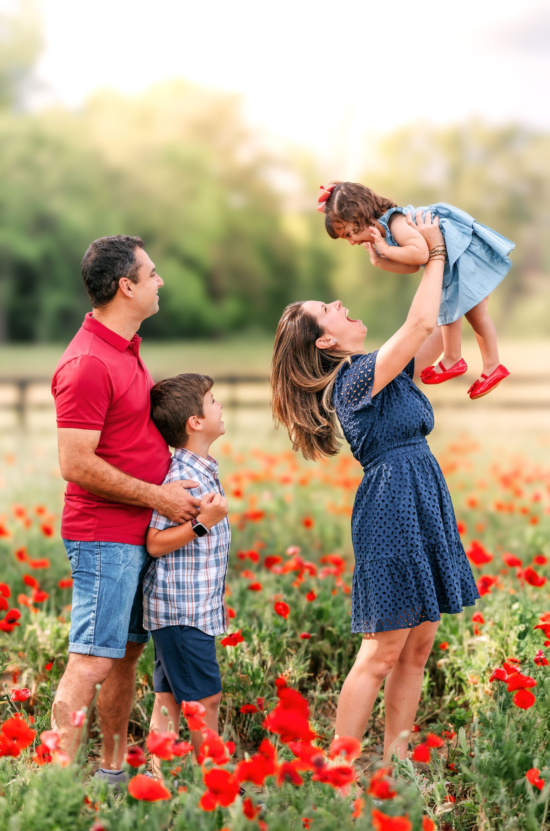 Mother and child portrait in a red poppy field on a sunny spring day in Raleigh, NC