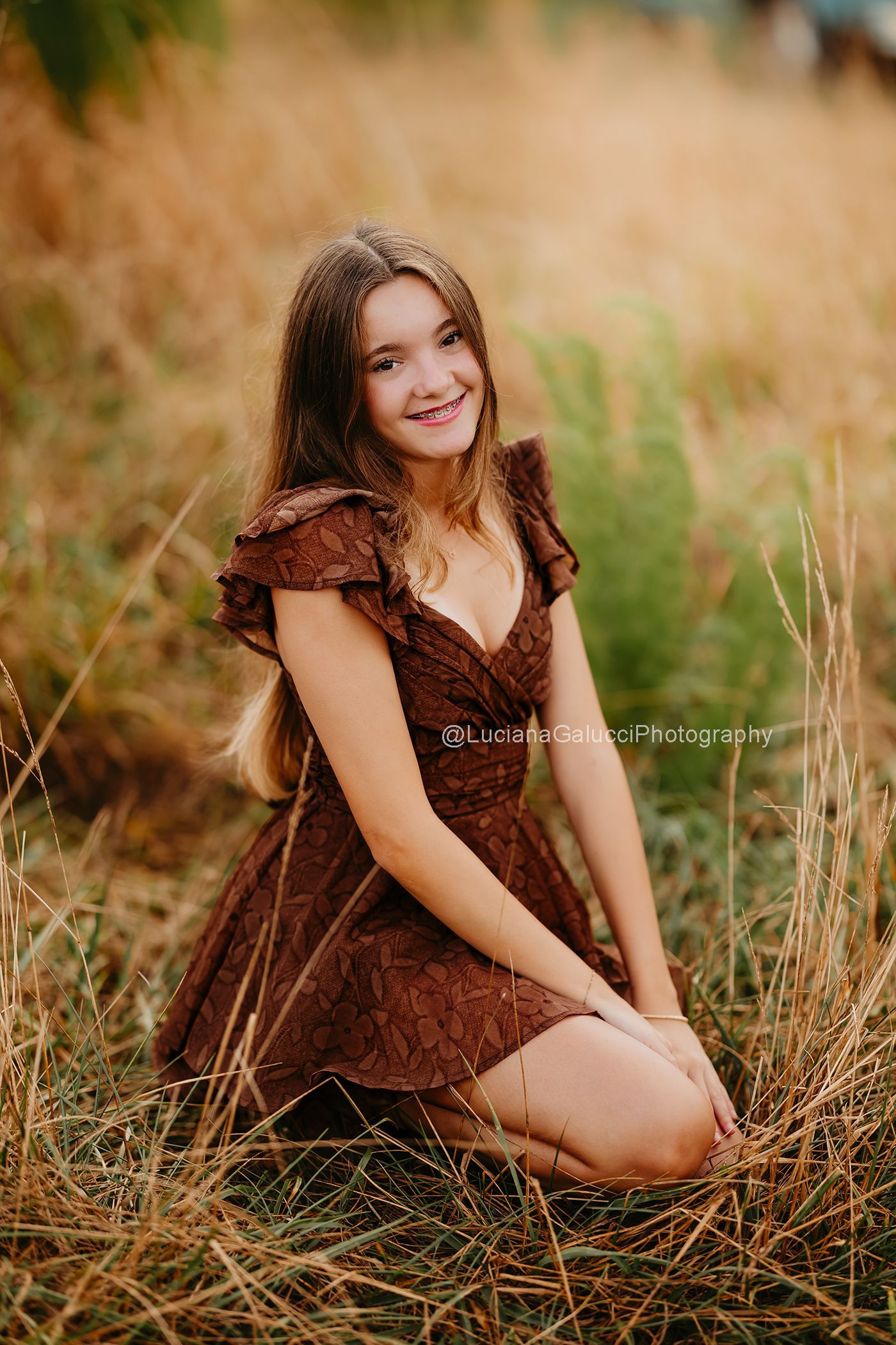 Beautiful outdoor child portrait surrounded by sunflowers and wildflowers.