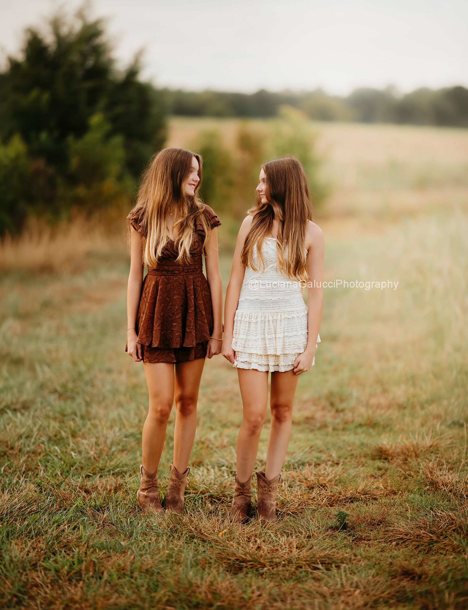 Twins Teenager sisters photoshoot at a golden tall grass field
in Raleigh NC