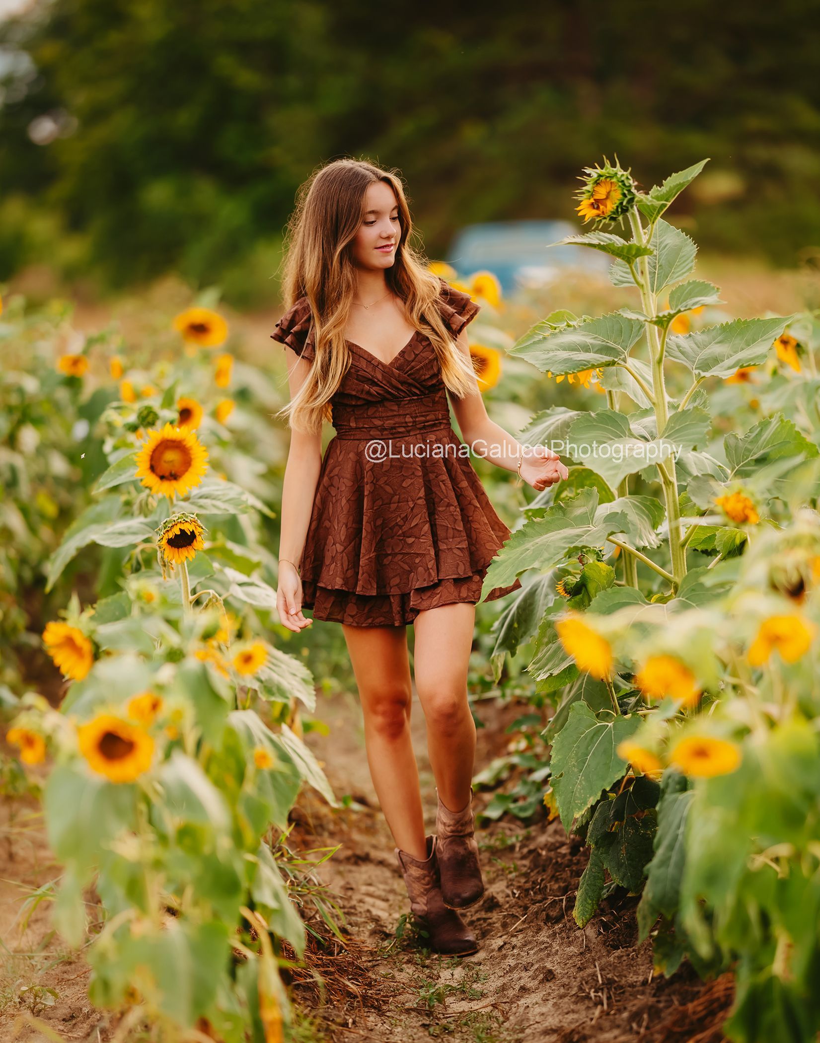 Candid tennager moment captured during a sunflower photography session in the Triangle area.