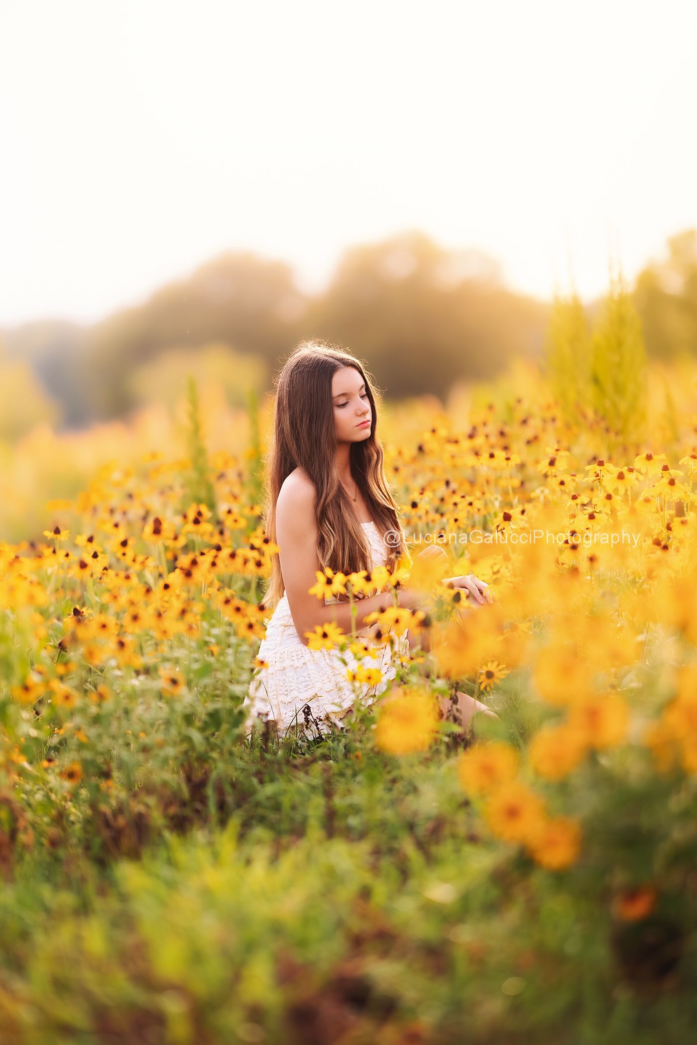 Portrait of a teenage girl in a wild flower field near Raleigh.