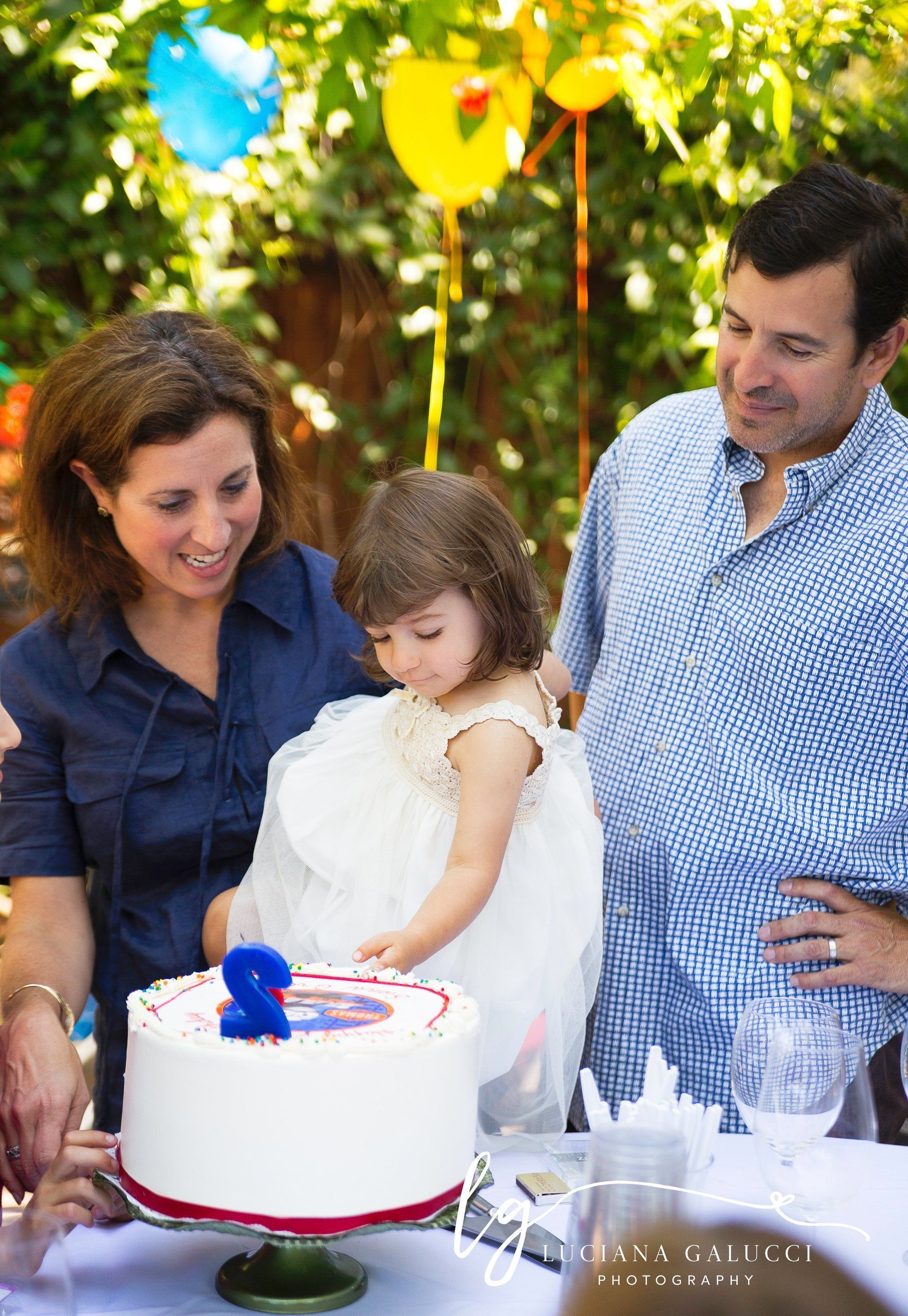 parents and toddler girl portrait at the birthday party in Raleigh NC