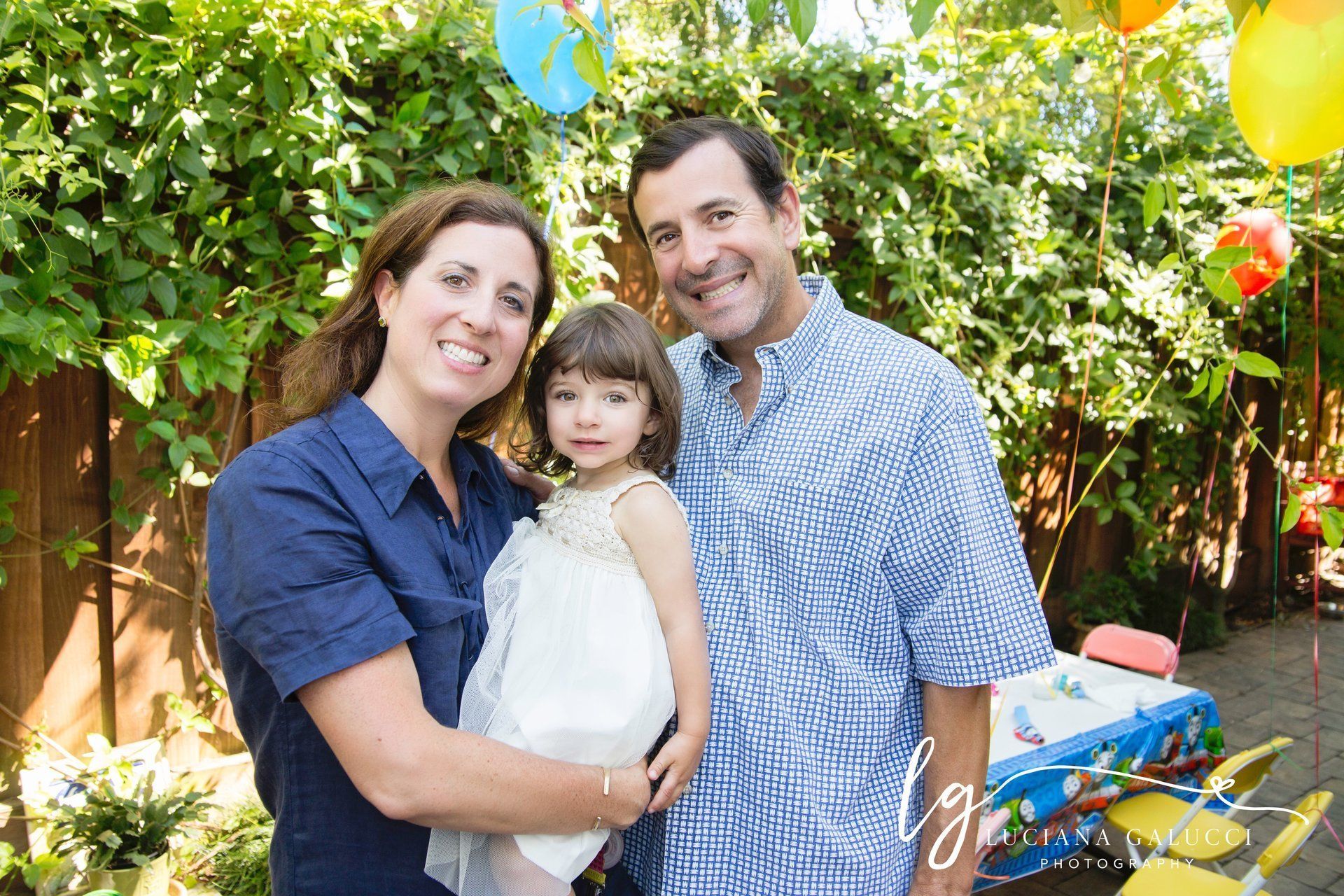 Parents and birthday toddler girls posing for a photo