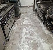 A kitchen with a lot of foam on the floor.