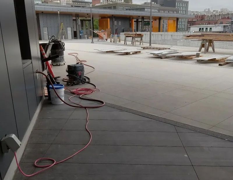 A vacuum cleaner is sitting on a tiled floor