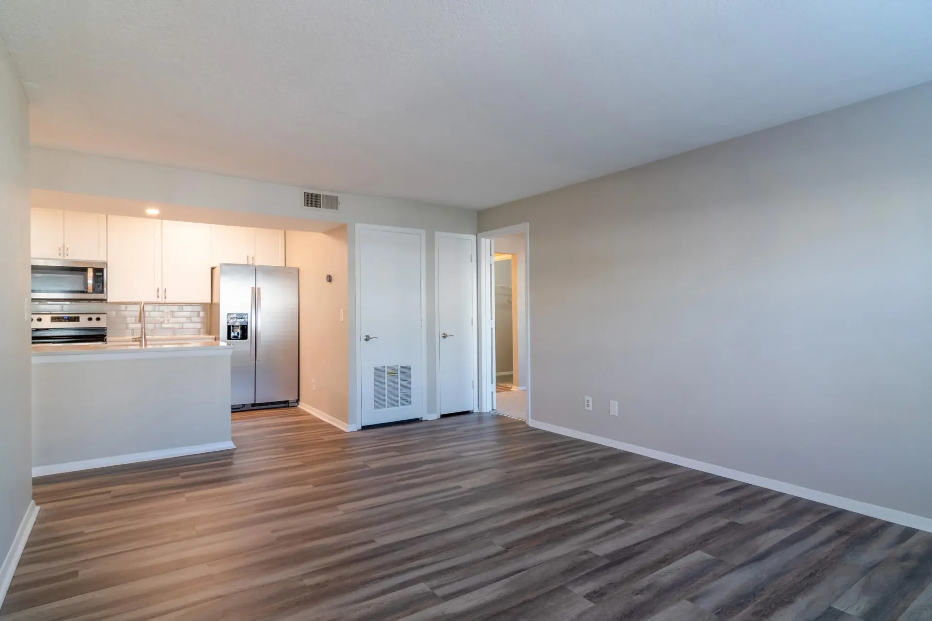 Living room with hardwood floors and kitchen view at 2100 Defoors in Westside Atlanta