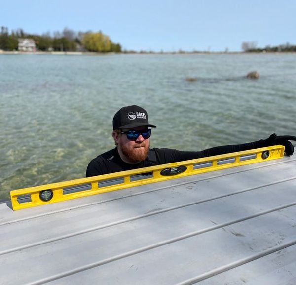 Docks Unlimited - Annual Maintenance An aluminum dock overlooking clear waters: A prime example of how to keep your dock in top shape with Docks Unlimited's annual maintenance service.