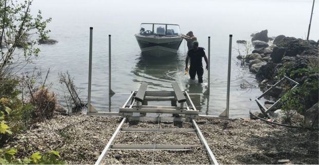 Docks Unilimited - Marine Railway and Crew An image of the Docks Unlimited crew assisting with moving a boat out of the water using a marine railway