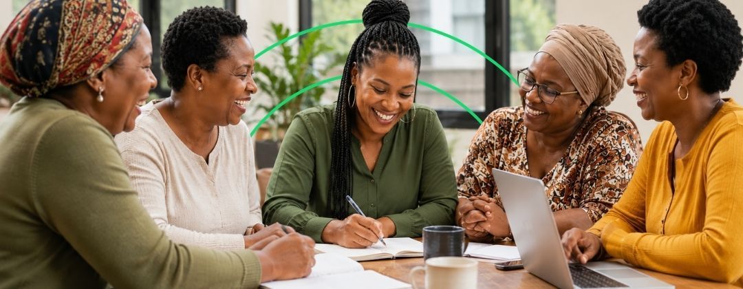 Group of smiling woman working around a table