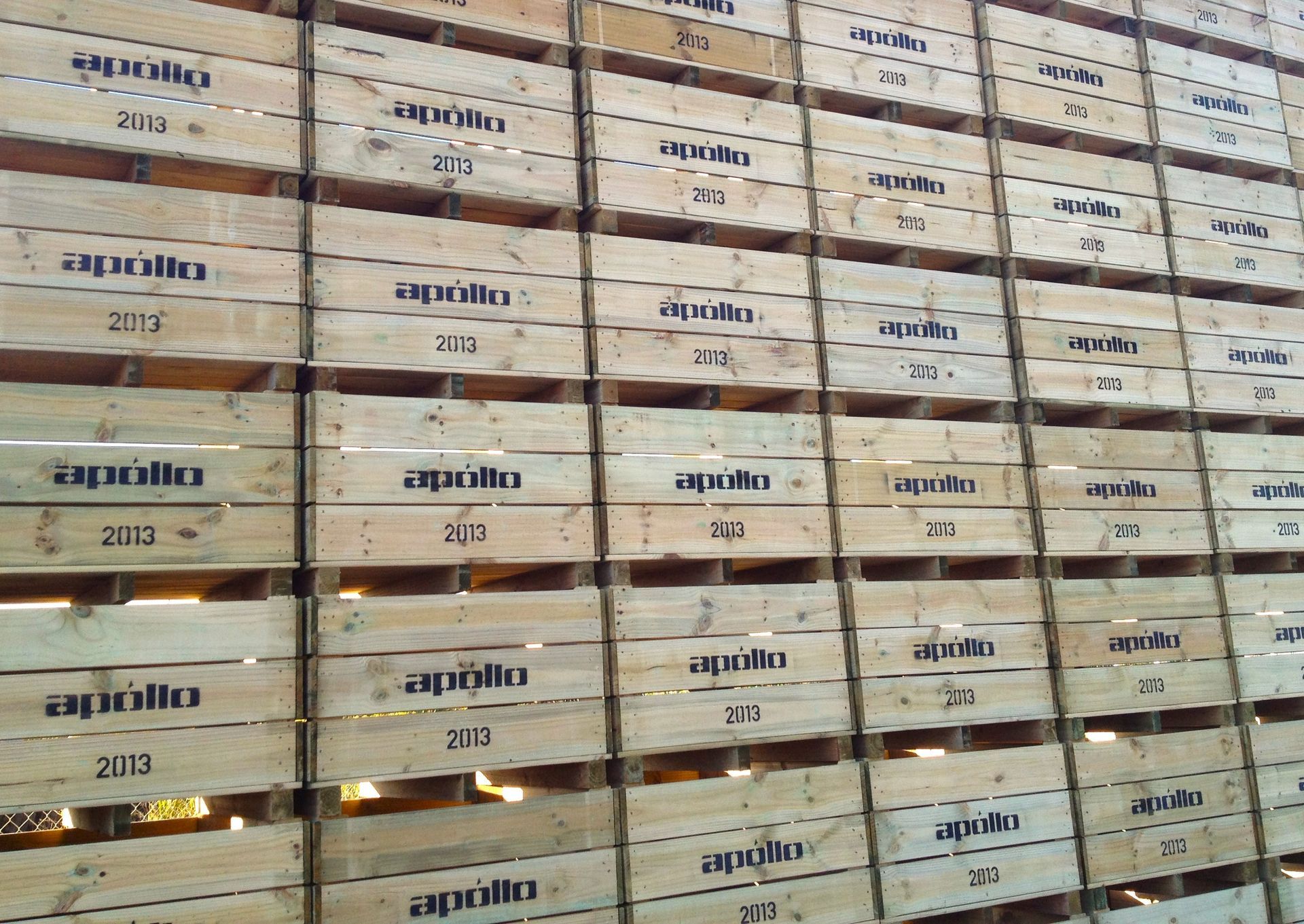 Stacked wooden crates in front of a slatted wood wall
