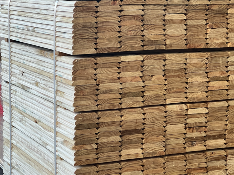 Wooden shipping crate with slatted lid and sides on a pallet in a warehouse