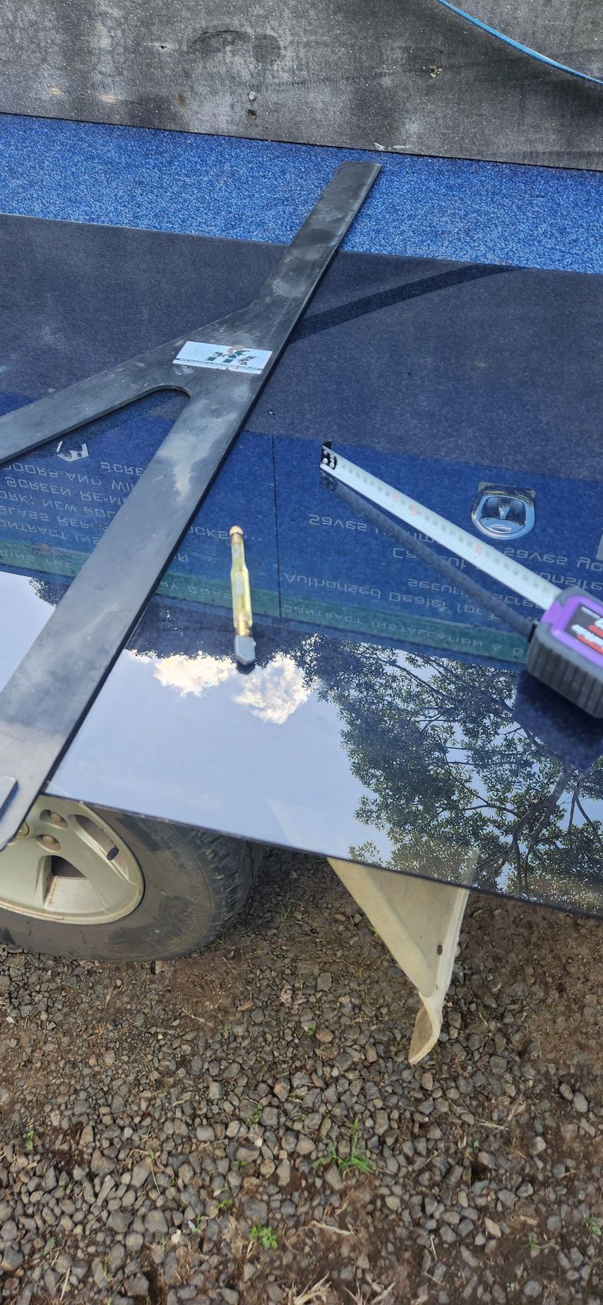 Tools on a blue and black surface with a screw being worked on - Advancetech Glass & Glazing in Wulguru, QLD