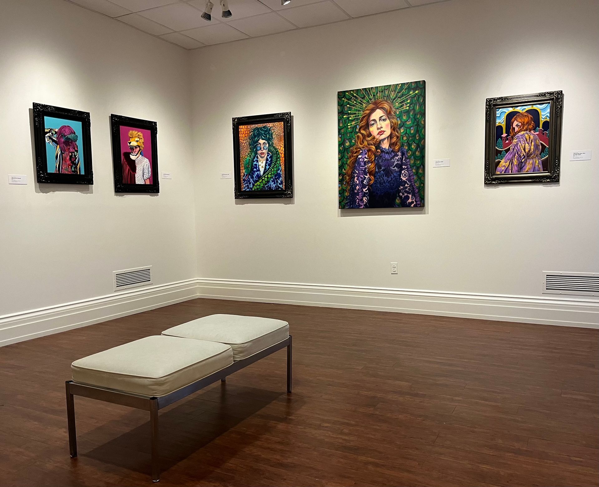 Two walls with paintings inside the Biggs Museum, 2023