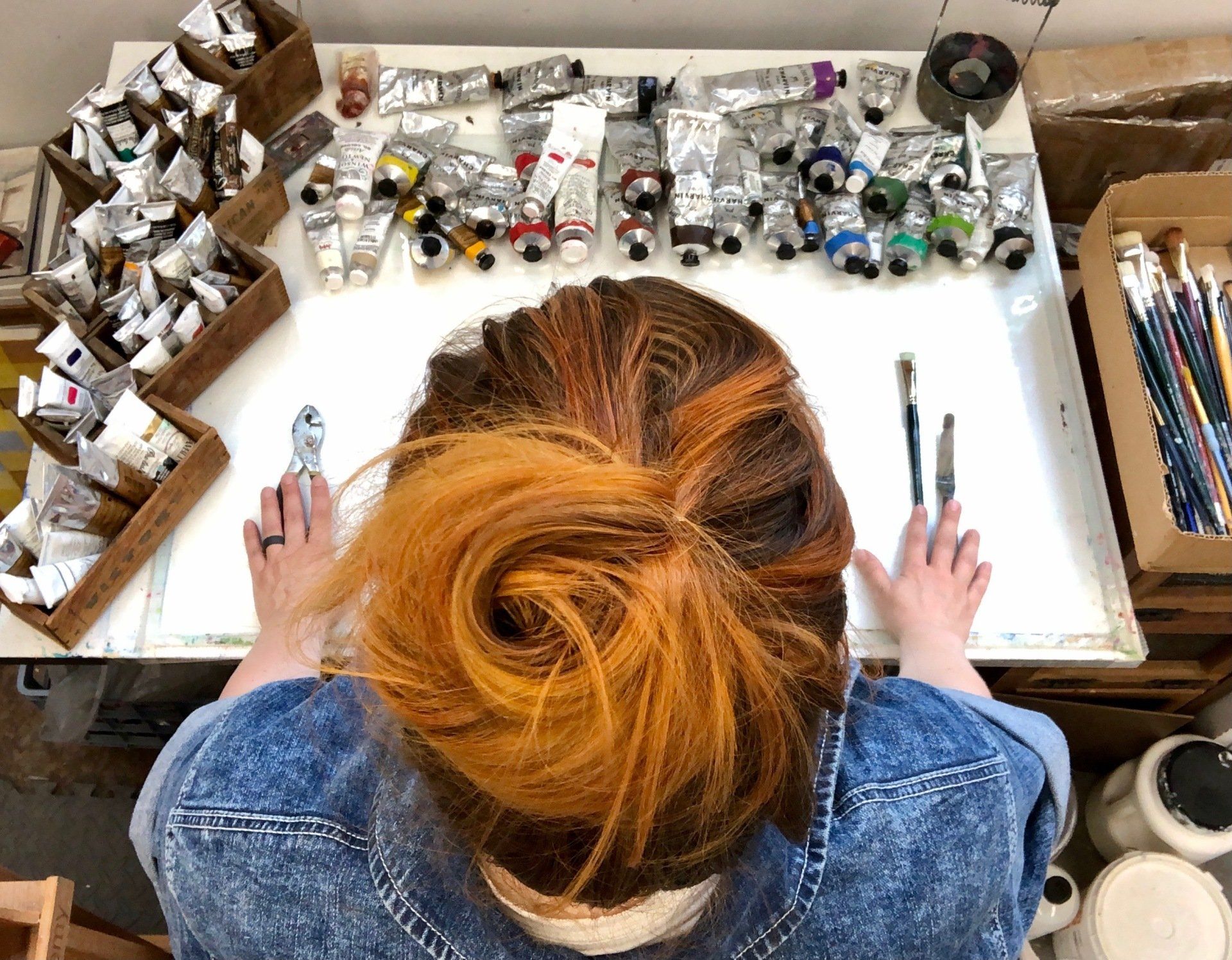 the artist standing over her palette