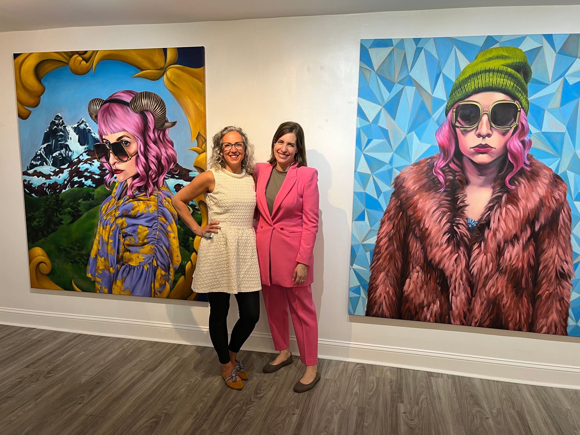 The artist and gallery owner in front of two 6-foot portraits by the artist, 2024